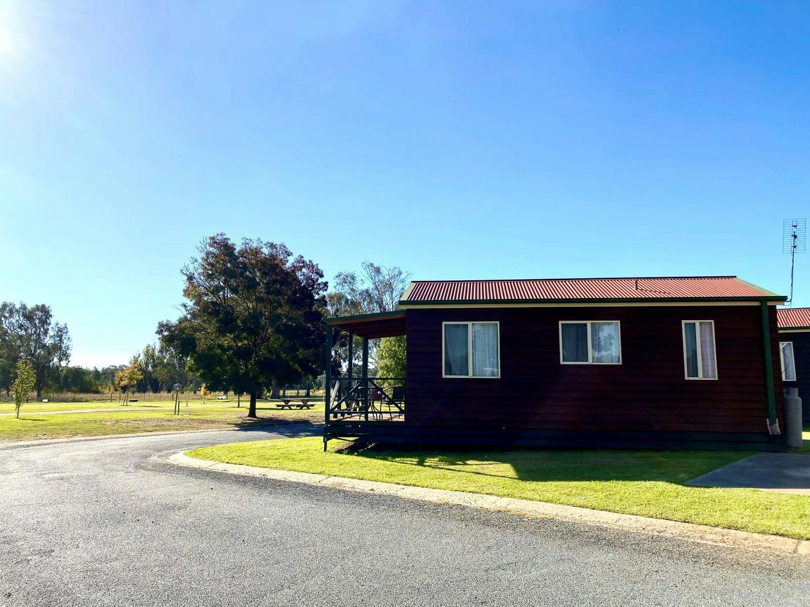 blue sky, green grass and side view of the front reception