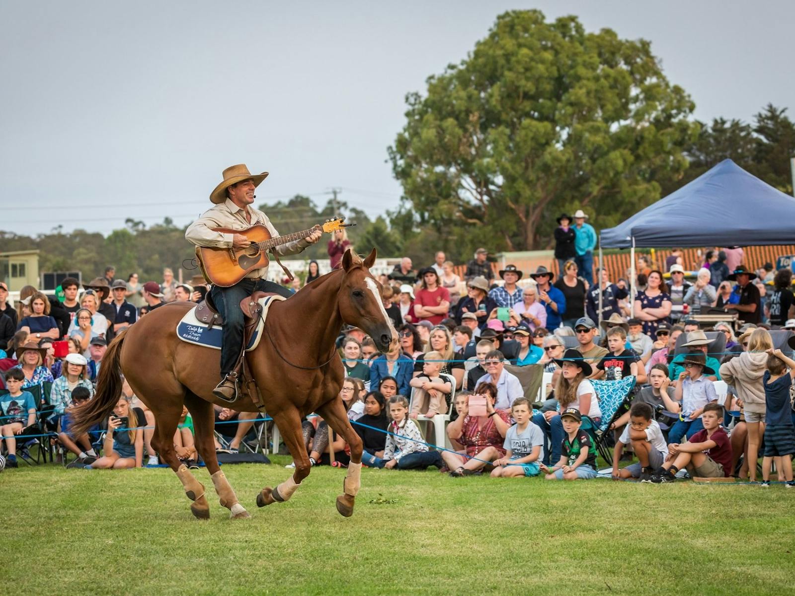 Tom singing on a horse