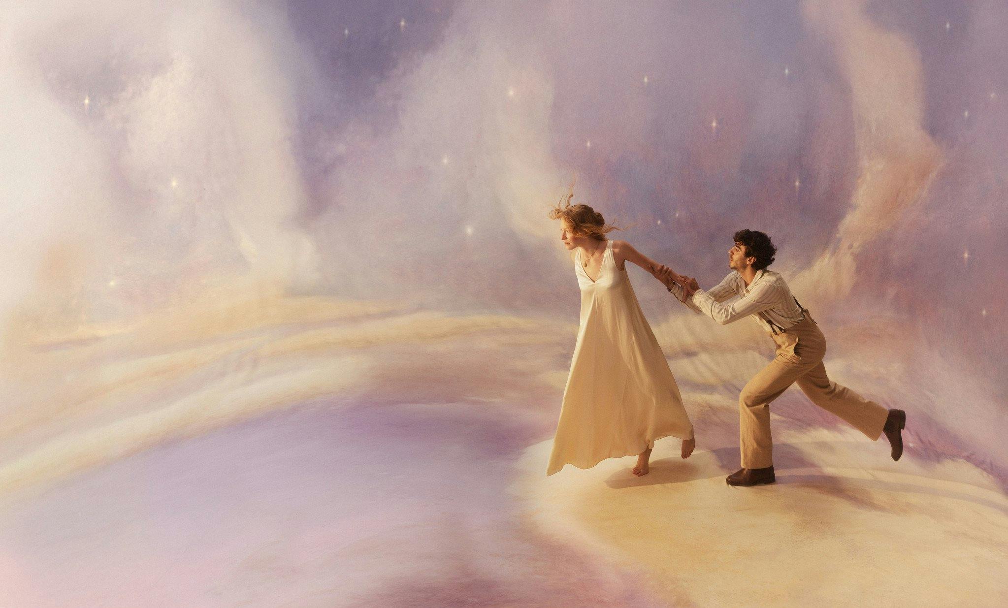 A woman in a white dress pulls a man across a dreamy, starry landscape.