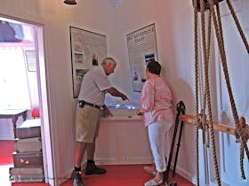 Visitors enjoying the interactive shipwreck map in the Margaret Brock Room