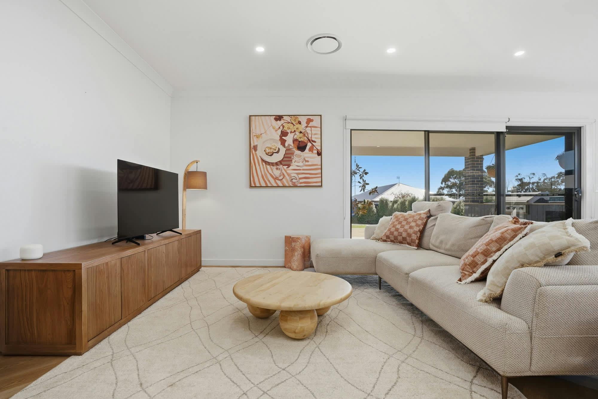 Lounge with tv, coffee table and large rug