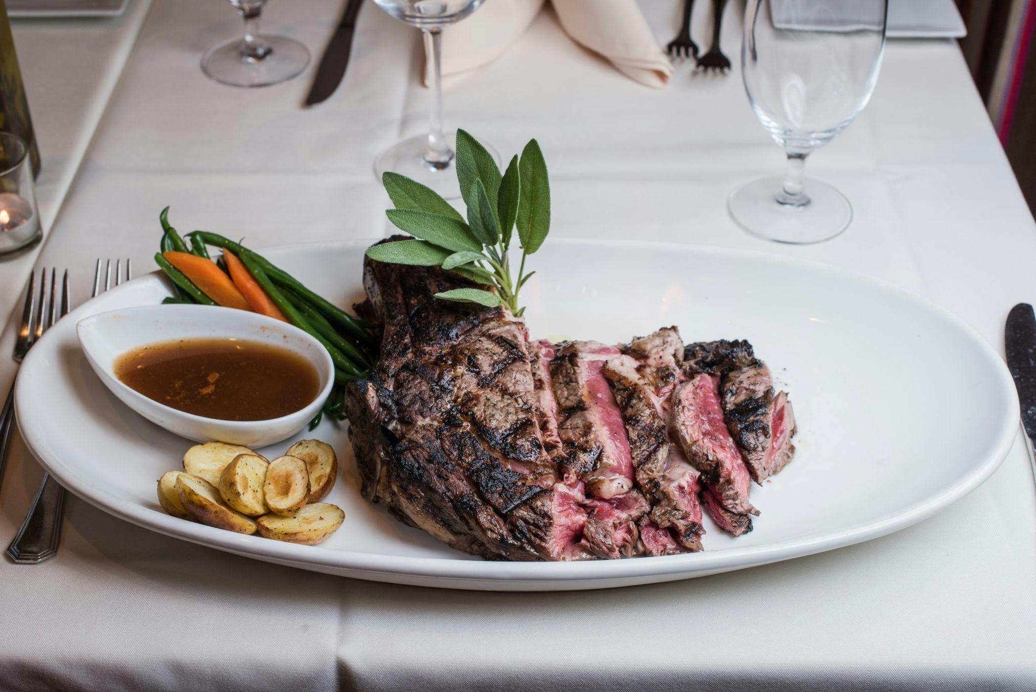 Steak and accompaniments on white plate