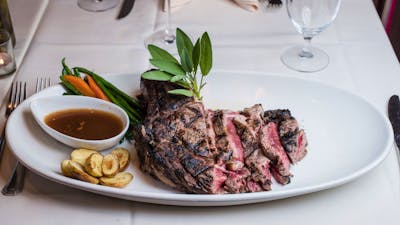 Steak and accompaniments on white plate