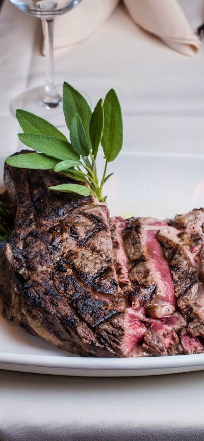 Steak and accompaniments on white plate