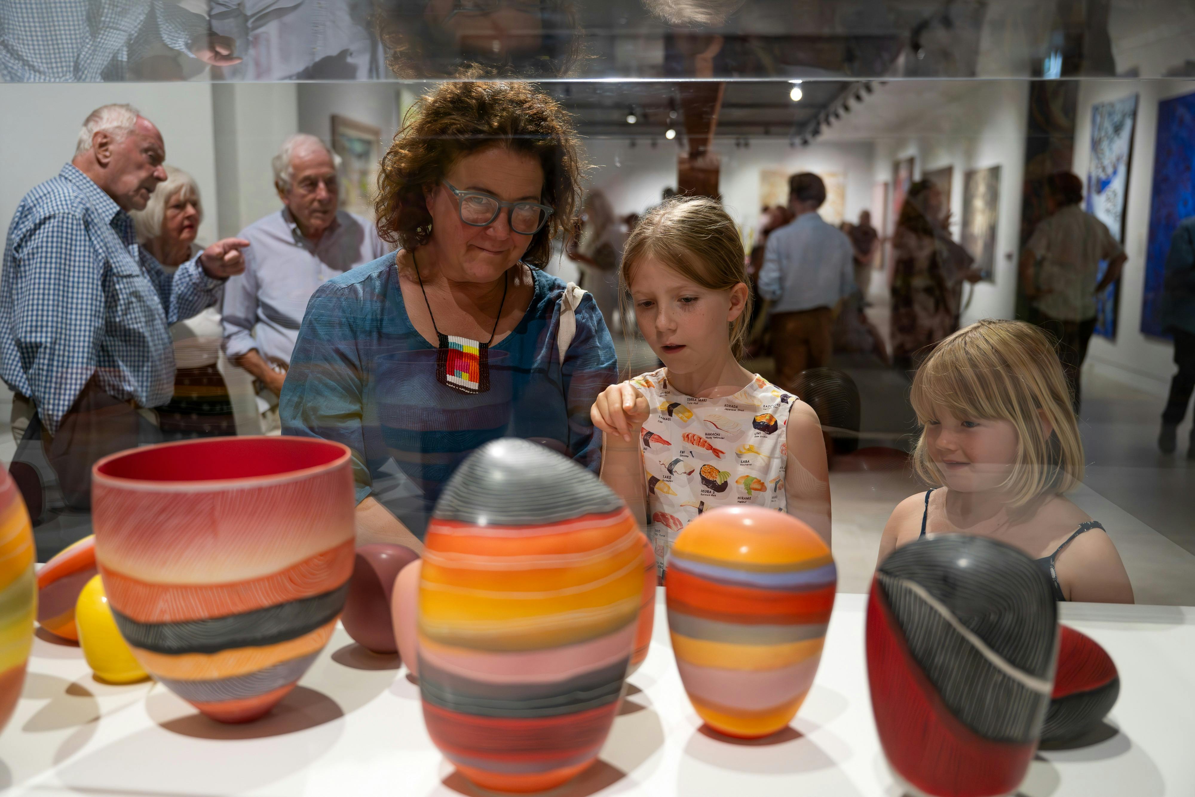 Woman and children viewing Pippin Drysdales  WOLFE CREEK CRATER ASSEMBLAGE, Breakaway Series 2023