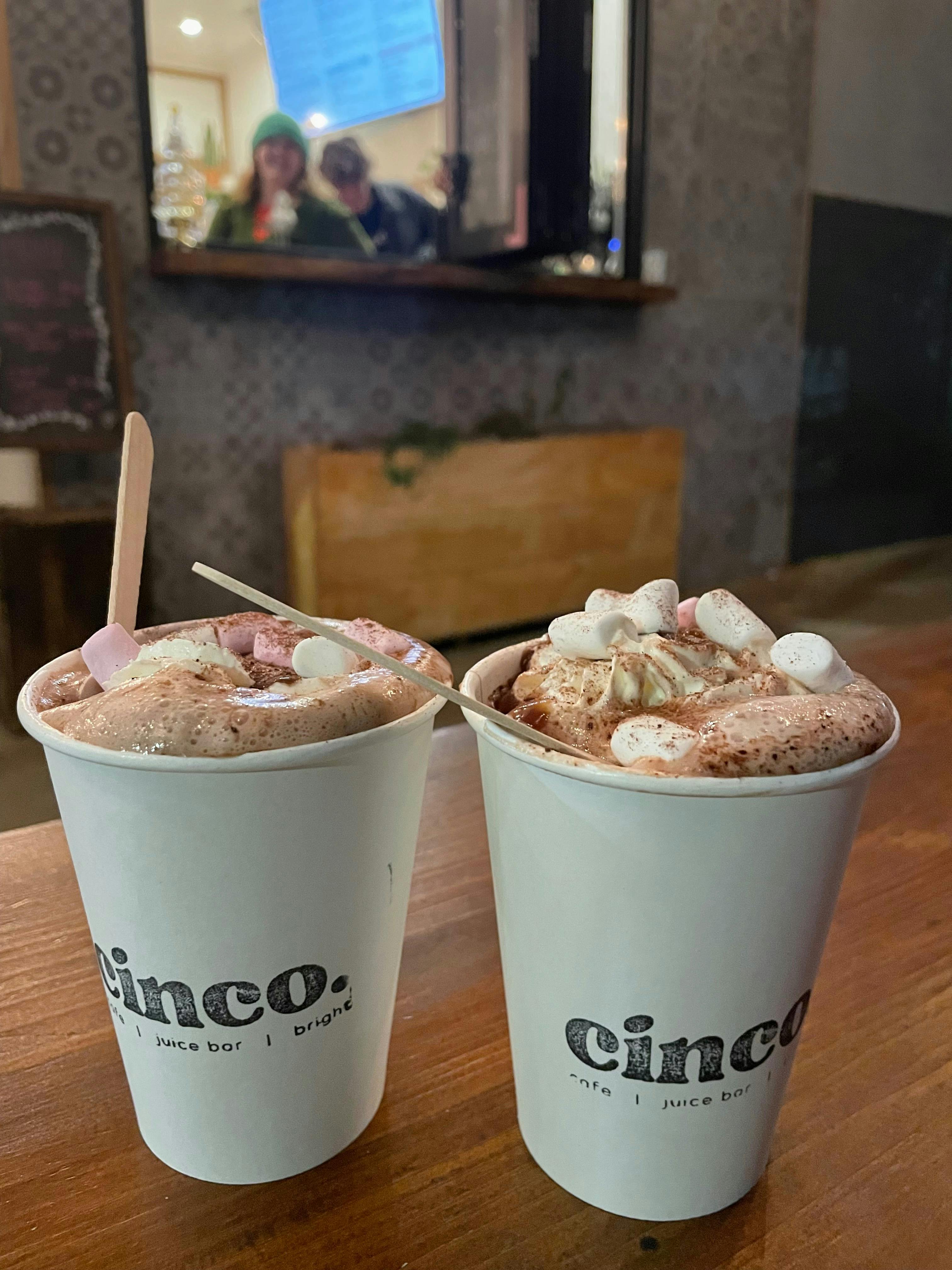 A photograph containing two hot-chocolates with marshmallows