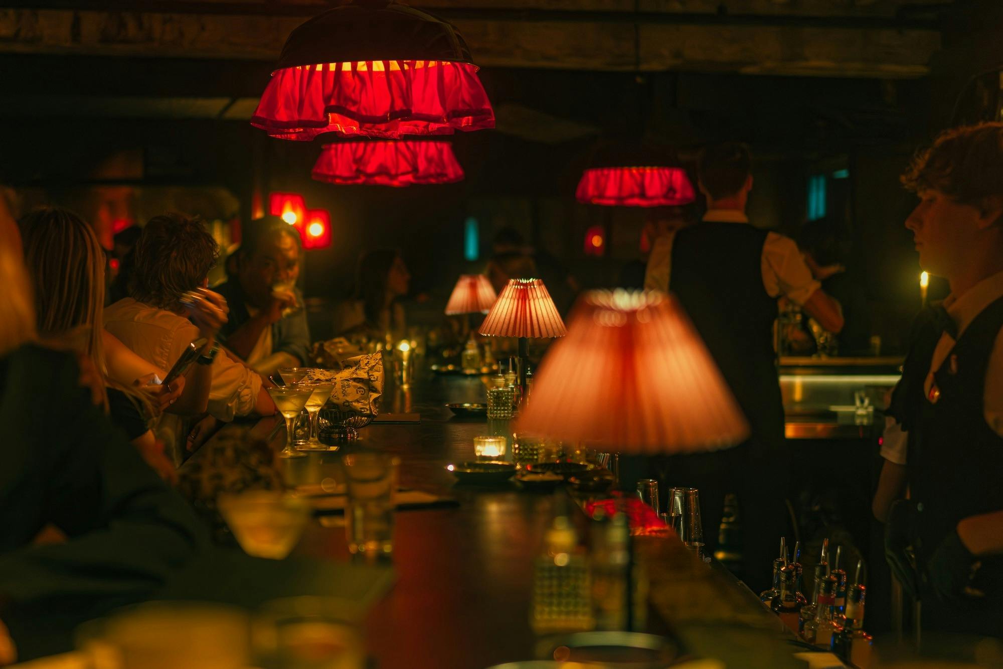 Guests seated at a busy bar during service