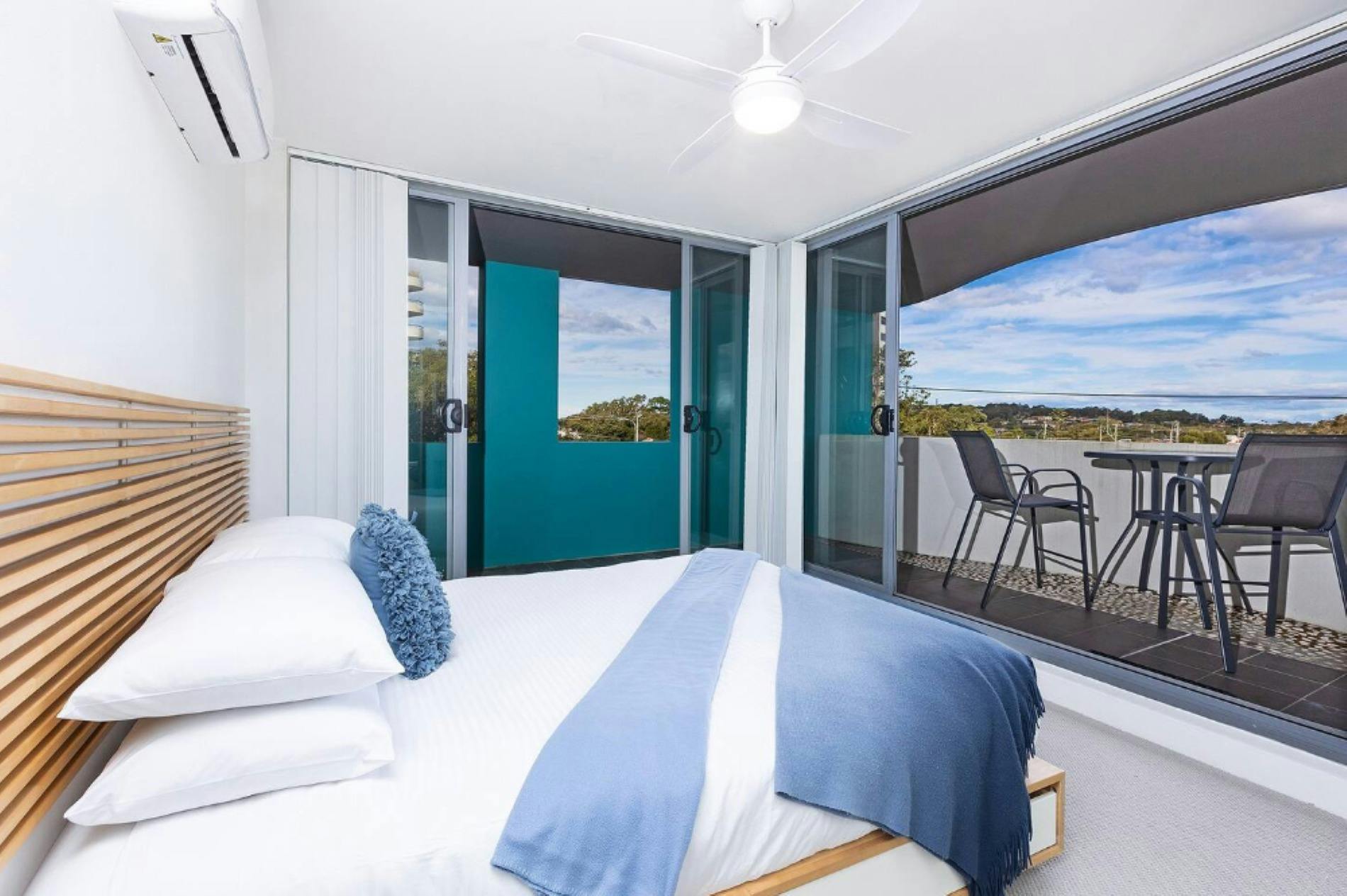 Master bedroom with Queen bed, private balcony, skyline views, high table setting