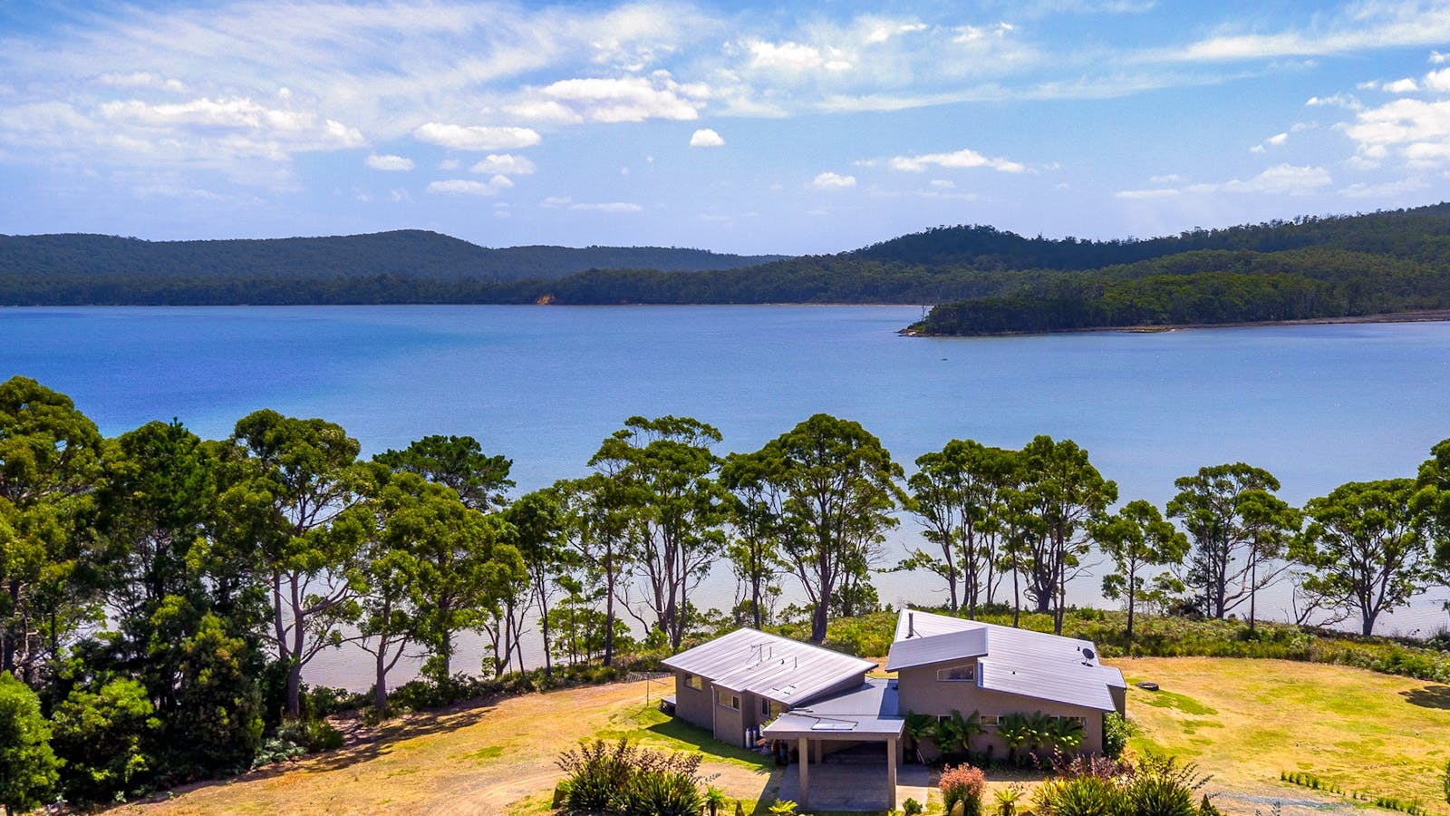 Cloudy Bay Lagoon Estate: aerial view of house and Cloudy Bay Lagoon on a sunny day.