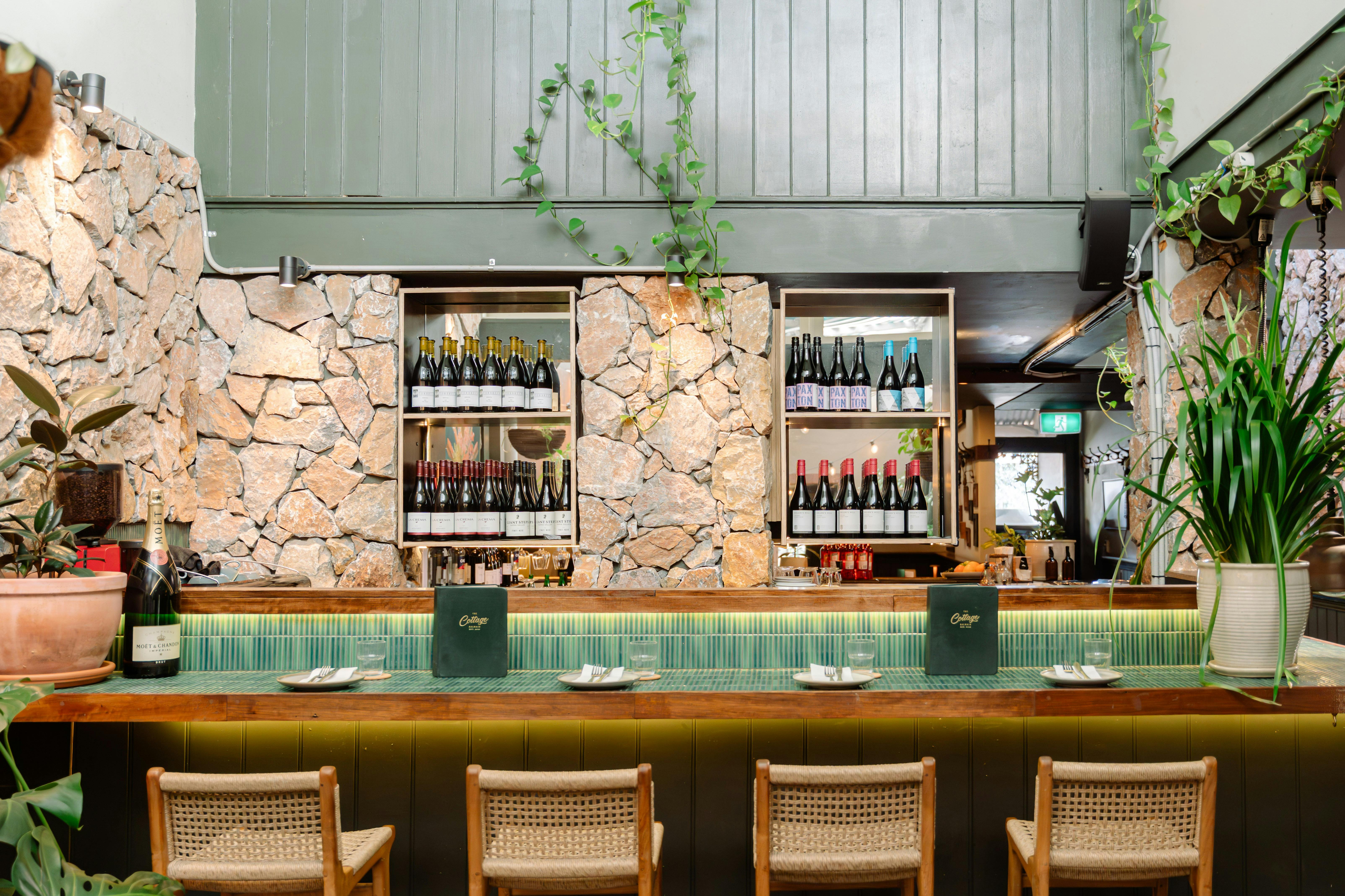 A well-lit interior view of a stylish restaurant bar.