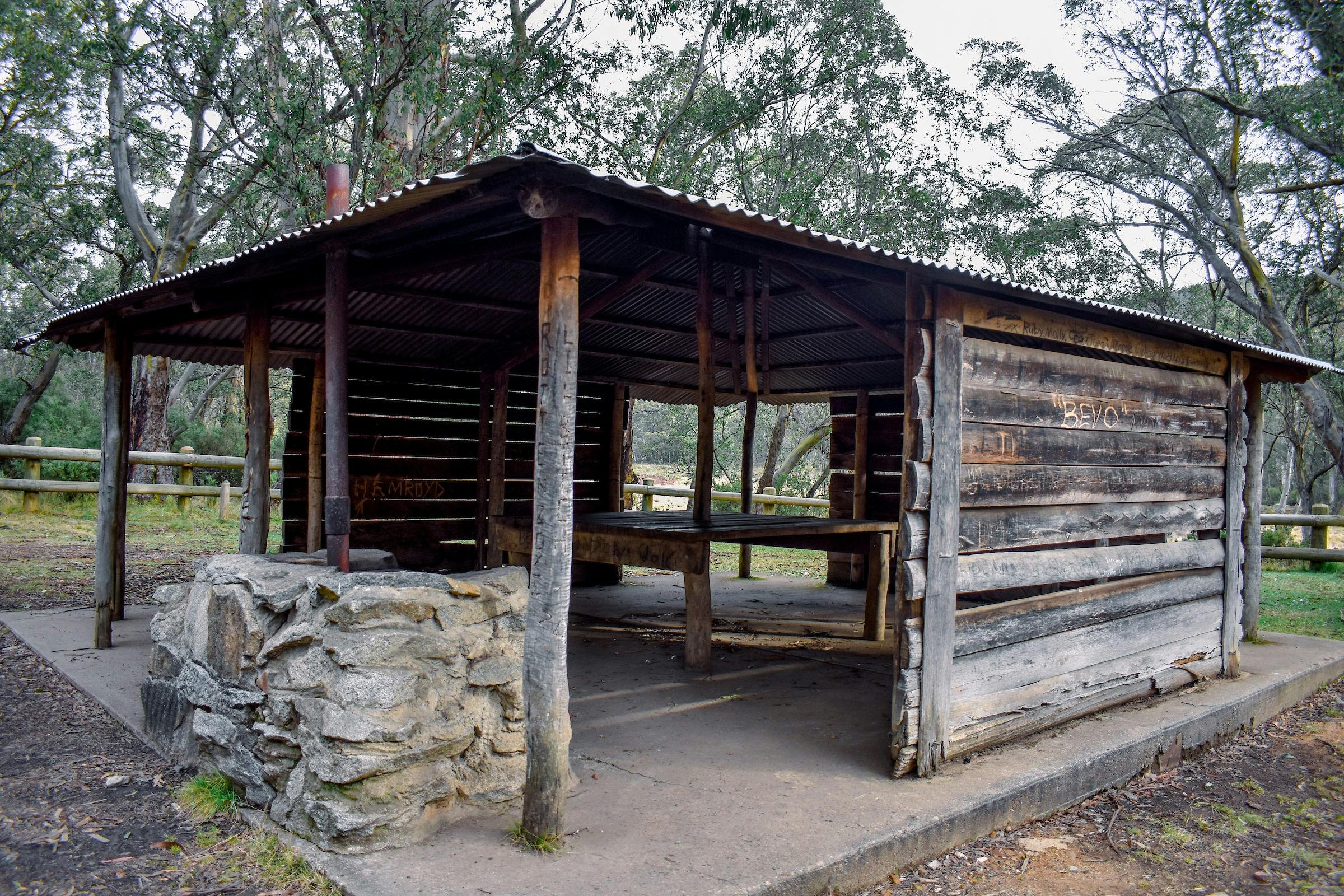 A wooden shelter surrounded by forest