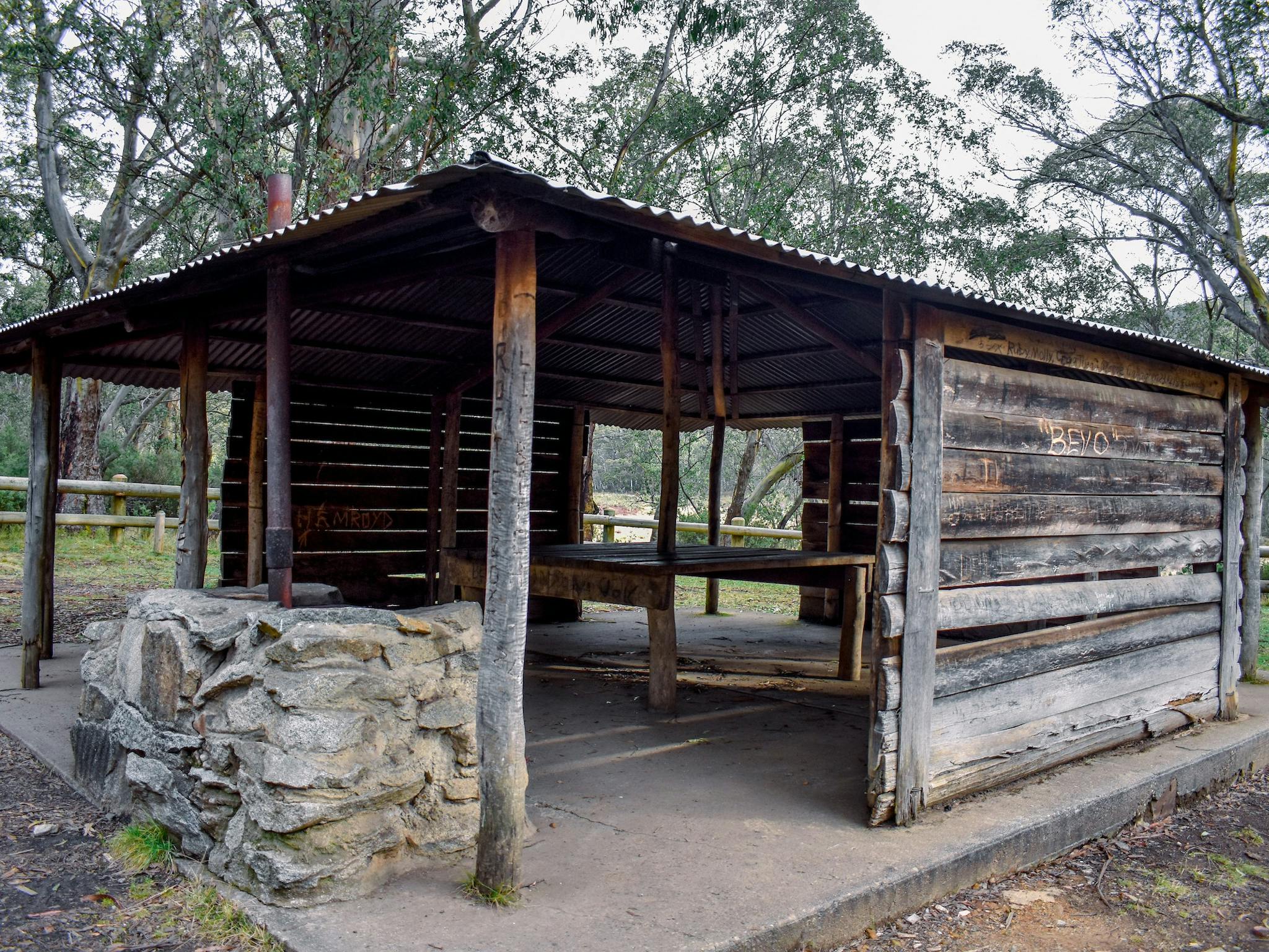 A wooden shelter surrounded by forest