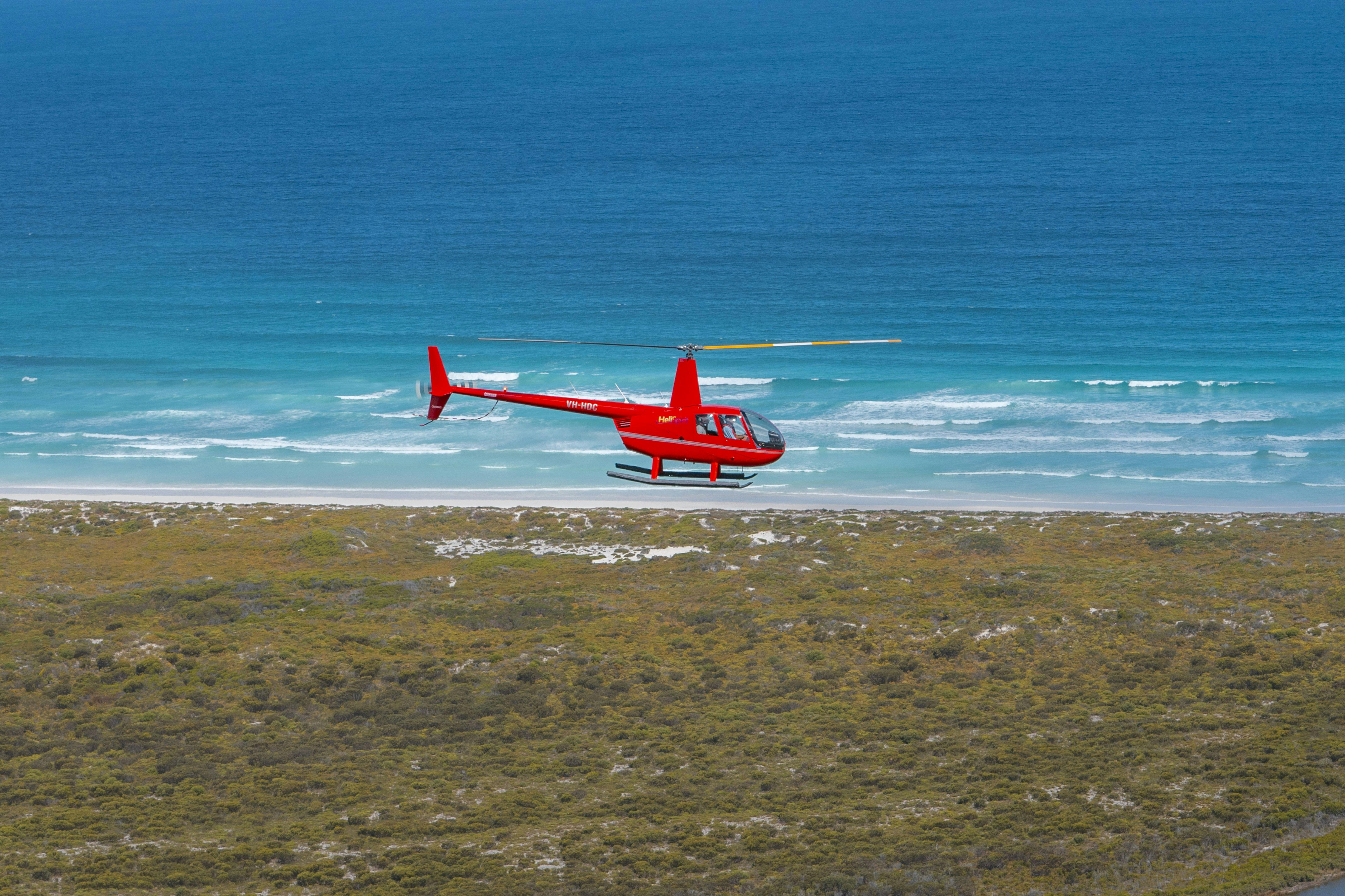 Helicopter flying over Esperance coastline