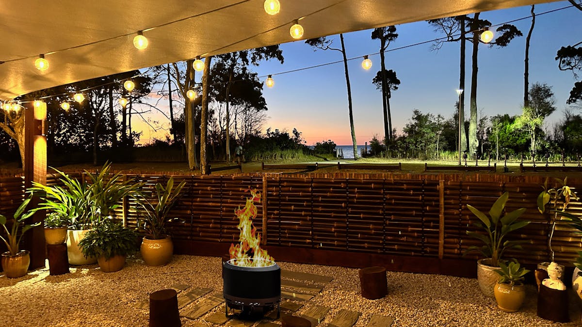 Vila Paus Satu at sunset. Stunning views of the ocean, beautifully lit with festoon lighting.