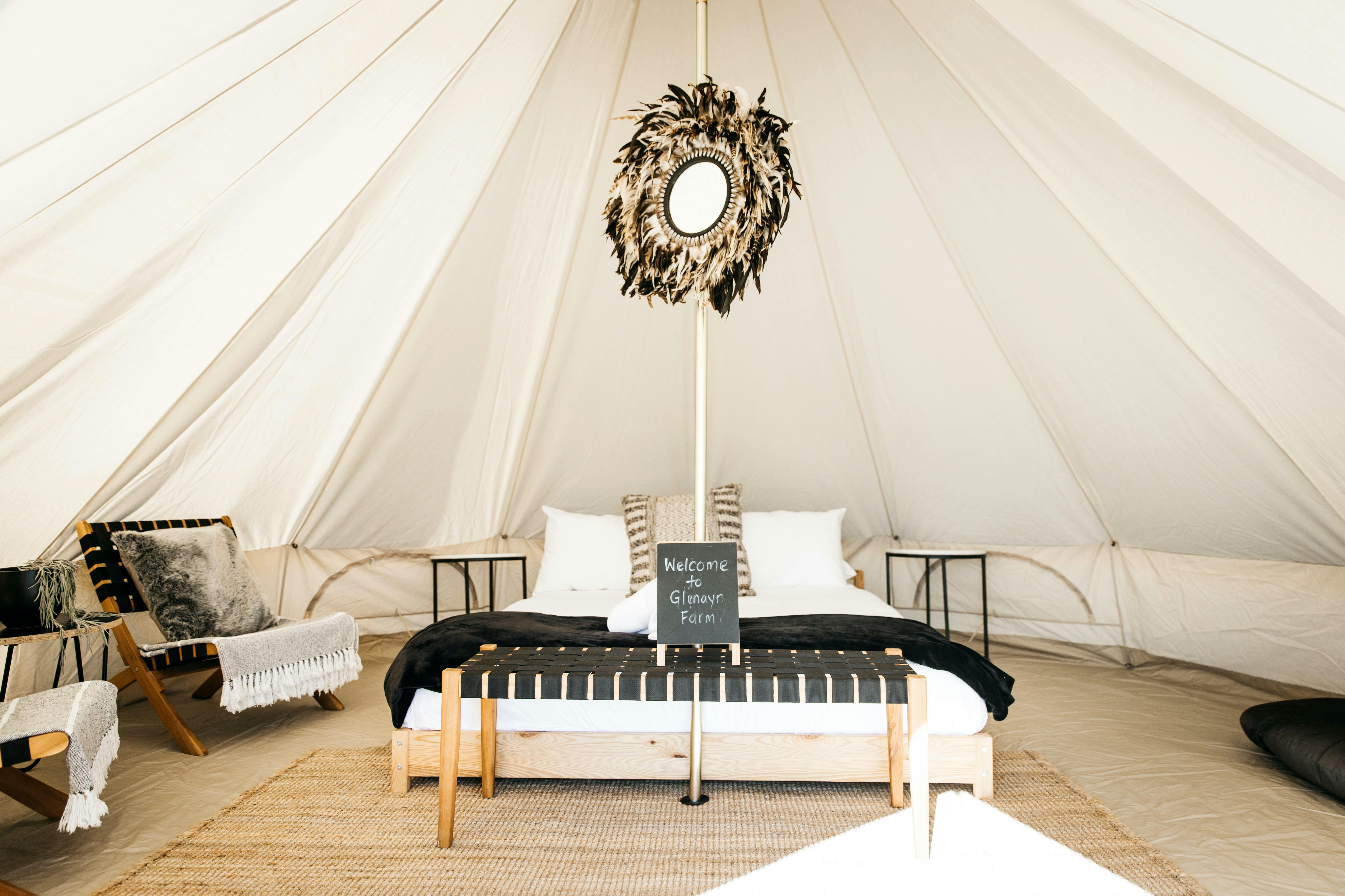 Our bell tents are a spacious 5m dia with stunning views, private dining and egg swings