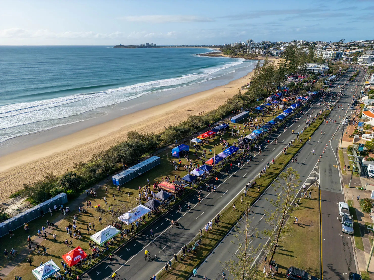 Team tents lining the course with the beach in the background