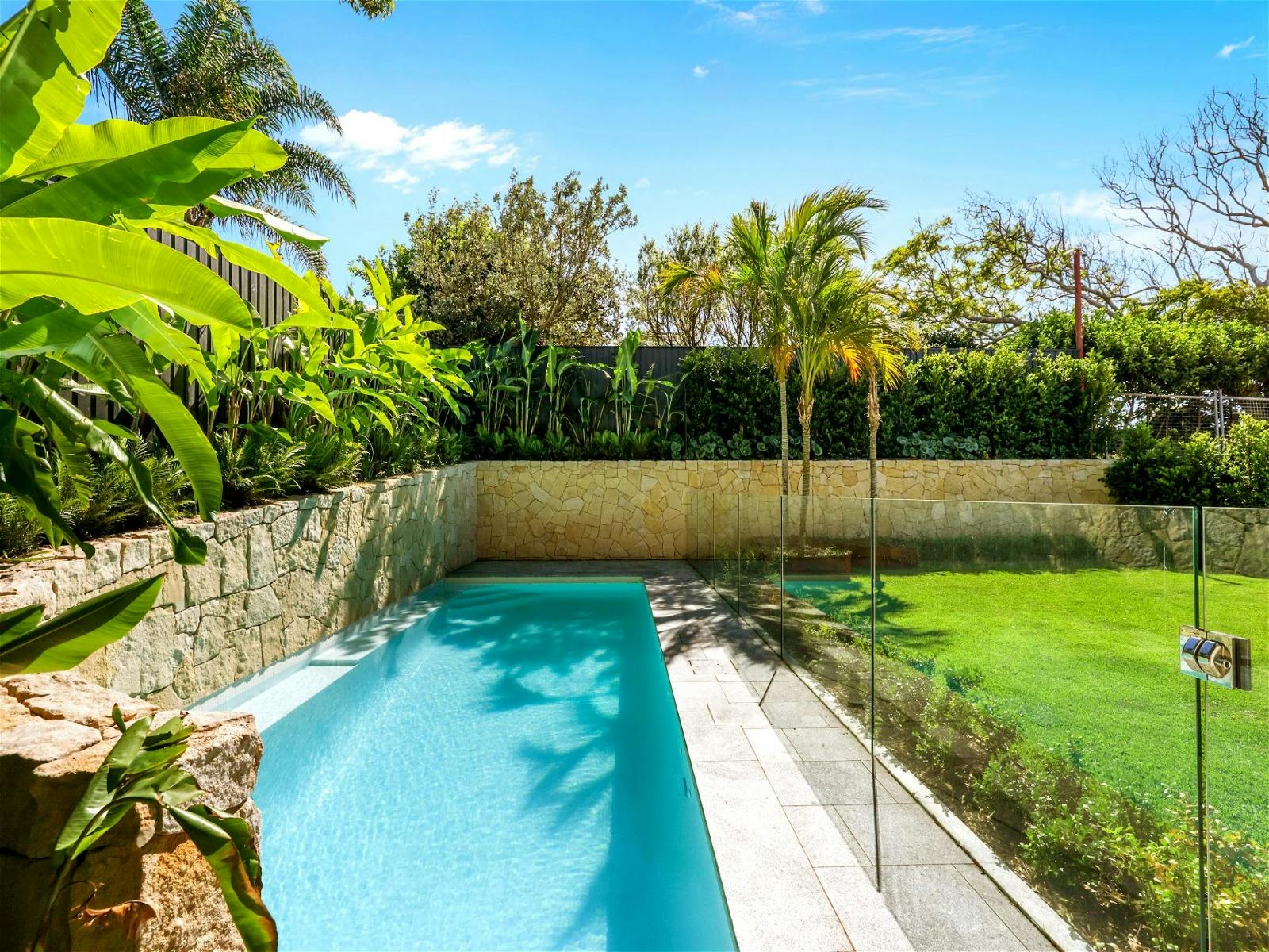 adorned with palm trees and beside the gas heated swimming pool