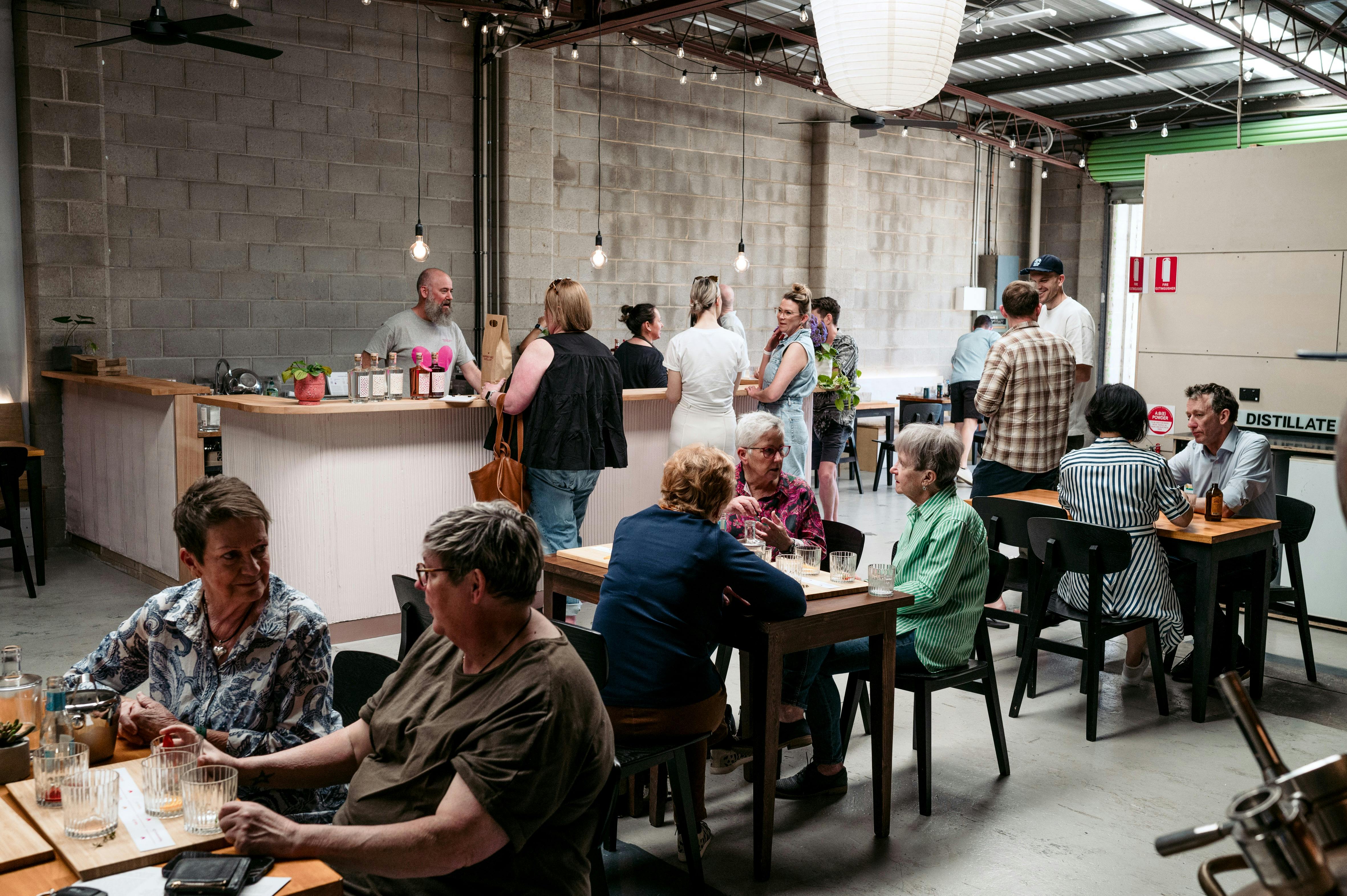 Distillery tasting room with guests and bar