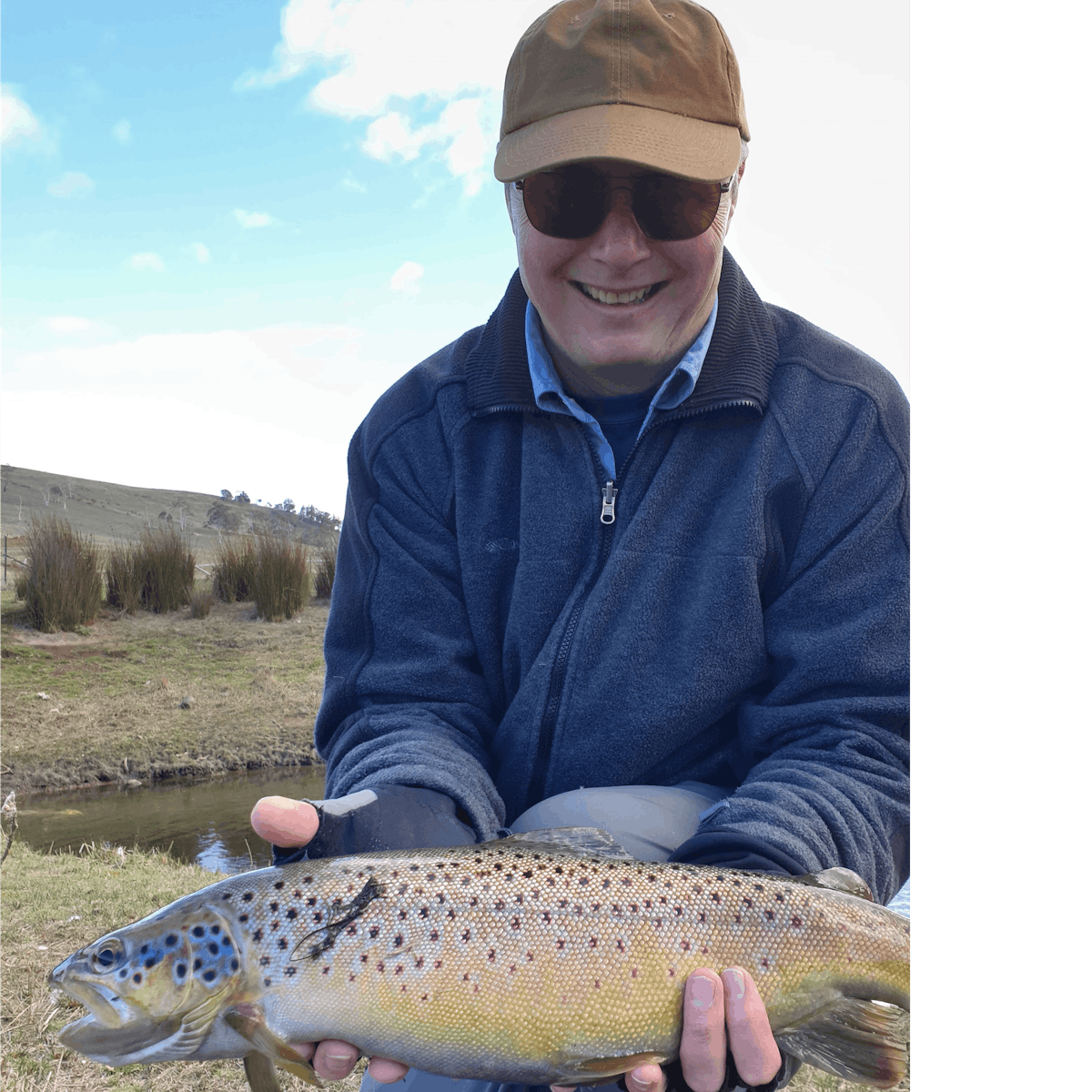 Client holding a large brown trout at 28 Gates before it is released