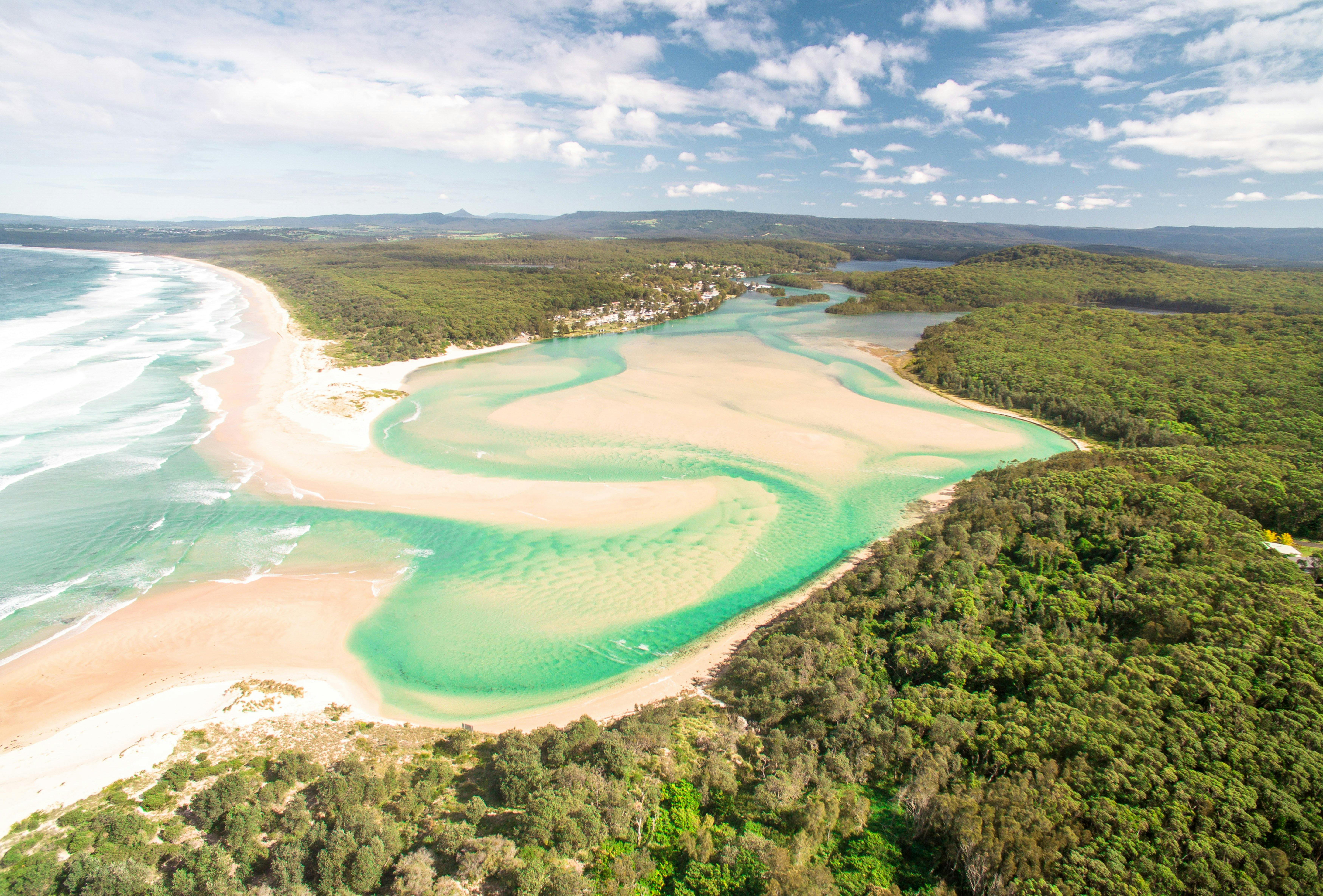 Aerial image of Conjola Entrance, surrounded by trees and mountains