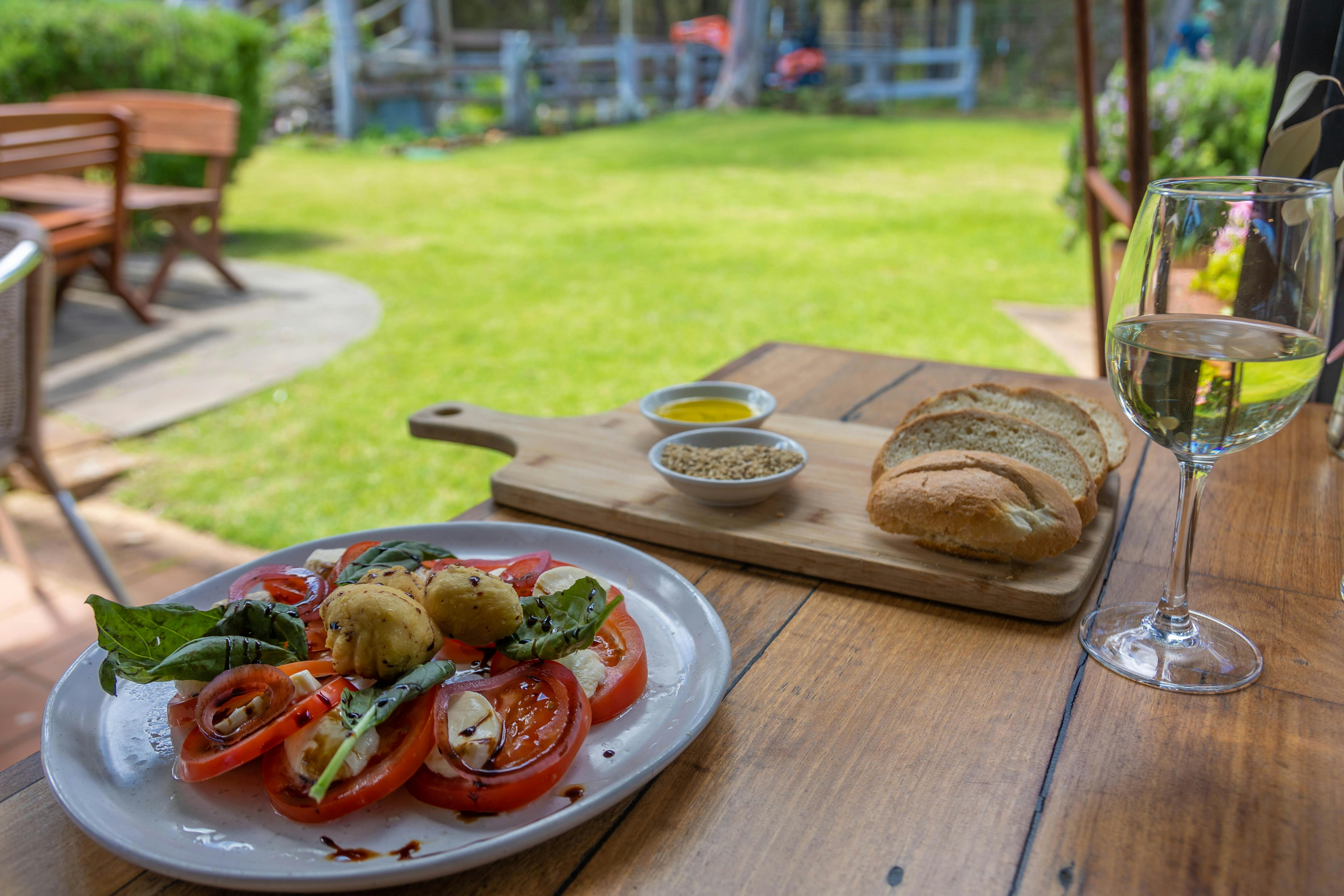 Sliced tomatoes and sliced bread set for lunch.