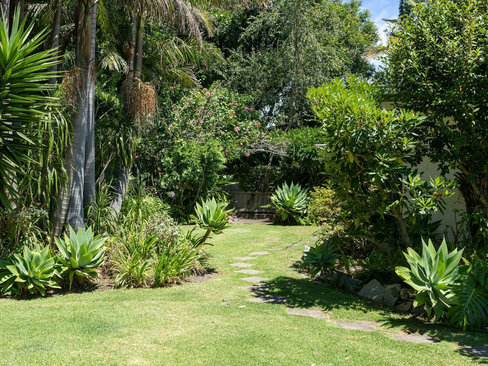 Garden path through lush greenery at Silver Bream Motel Mallacoota
