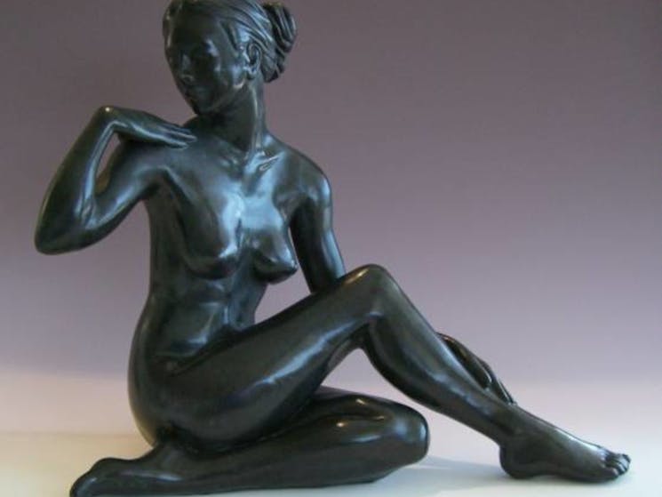 a bronze sculpture of a woman
