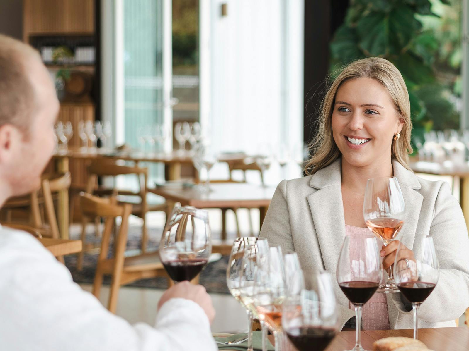 A couples smiling and enjoying wine during a tasting experience at the Wonder Room