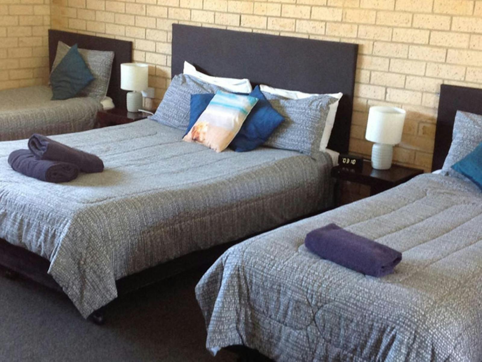 Image of two queen size beds with one single bed