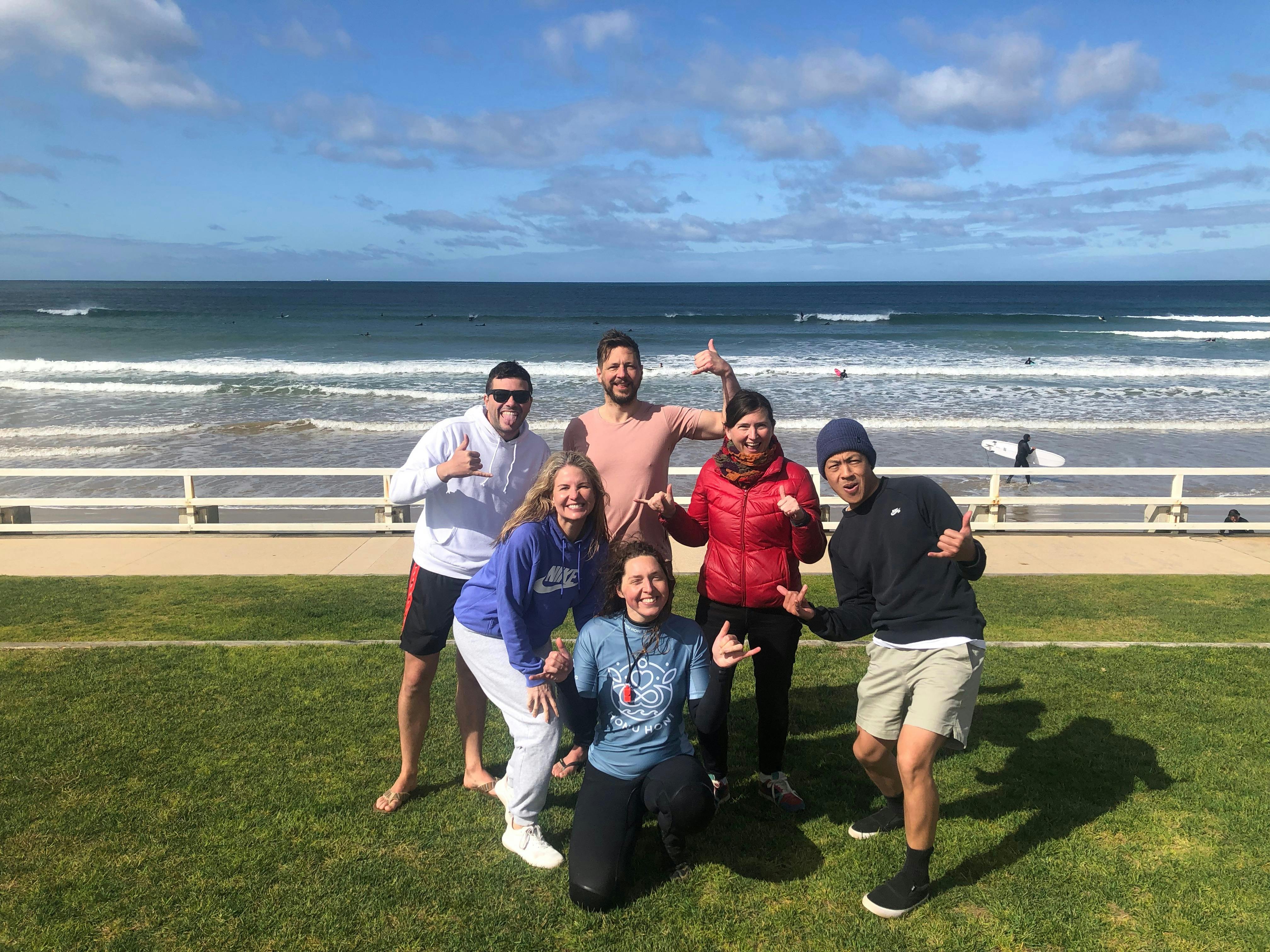 Post-surf shakas with an intermediate group surf lesson.