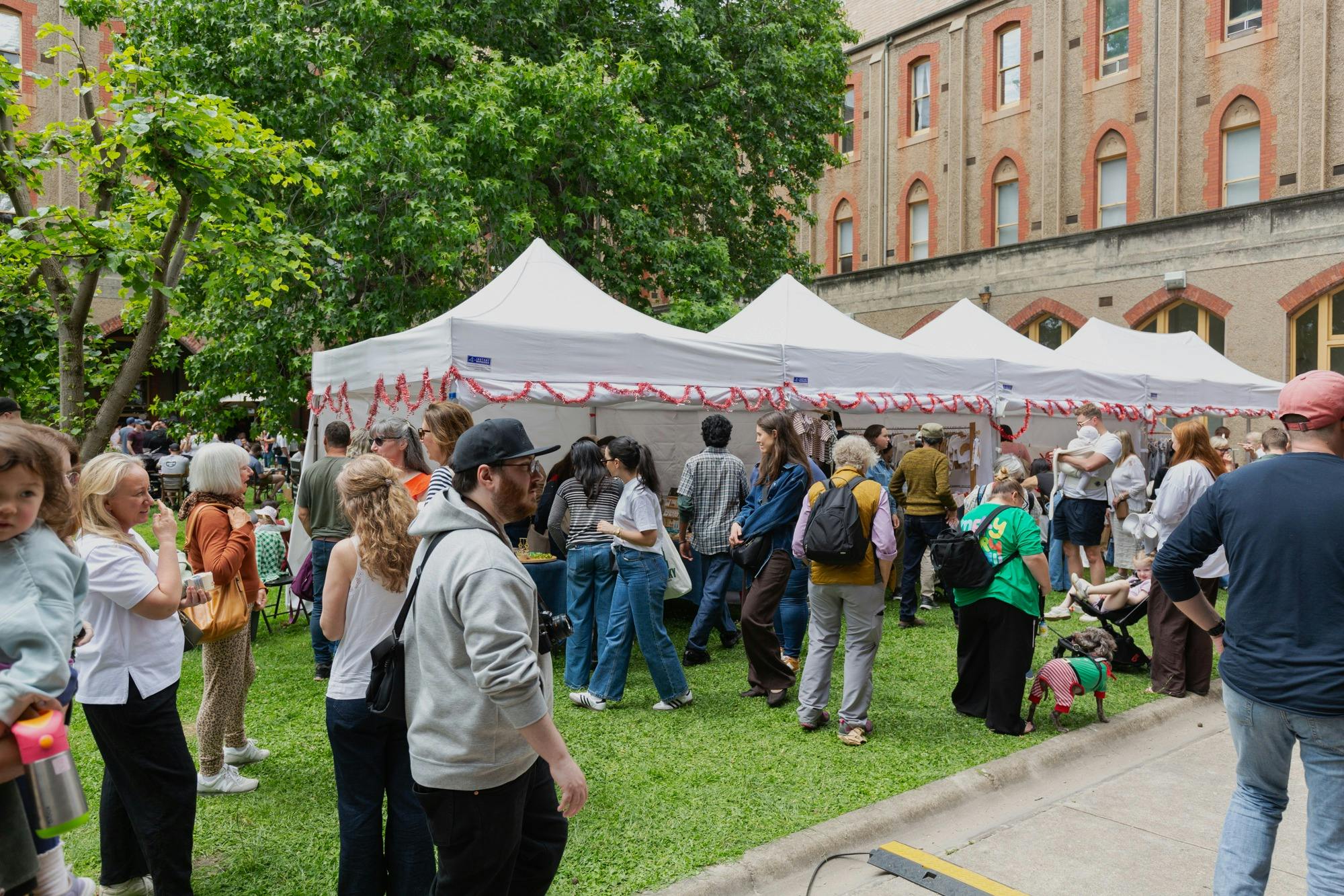people enjoying outdoor market at abbotsford convent.