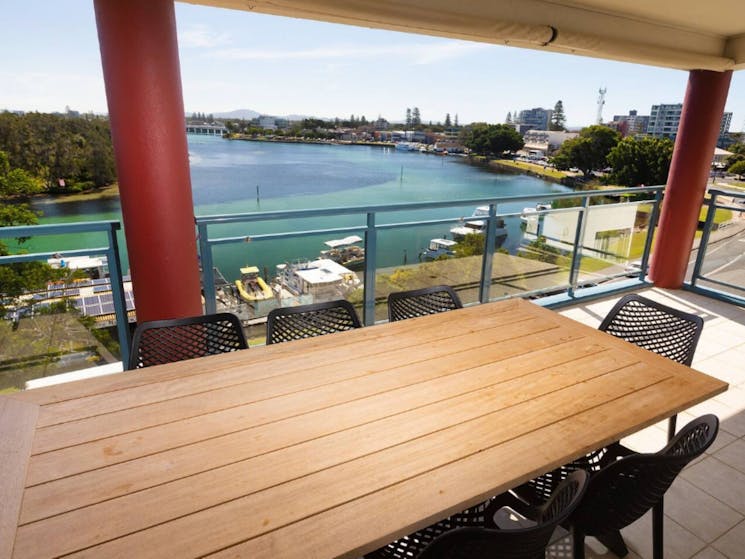 Balcony with panoramic lake views and dining setting
