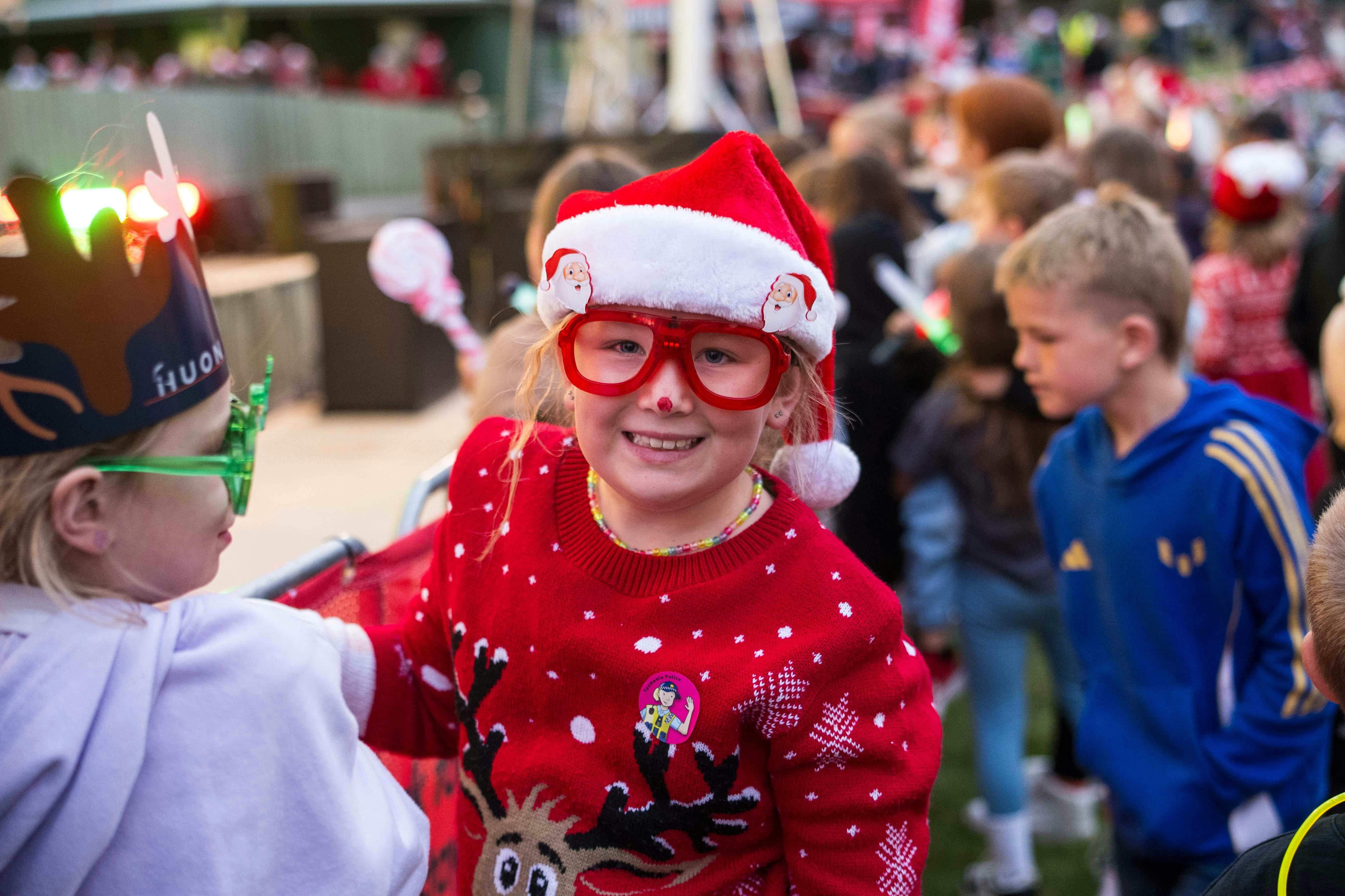 4yo girl with santa hat and festive red glasses and raindeer jumper