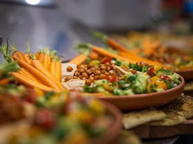 A beautful plate of homegrown carrots, with dip & tabbouleh & falafels & kofta