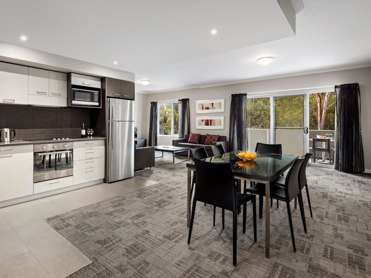 kitchen and dining area within the three bedroom apartment at Quest Campbelltown