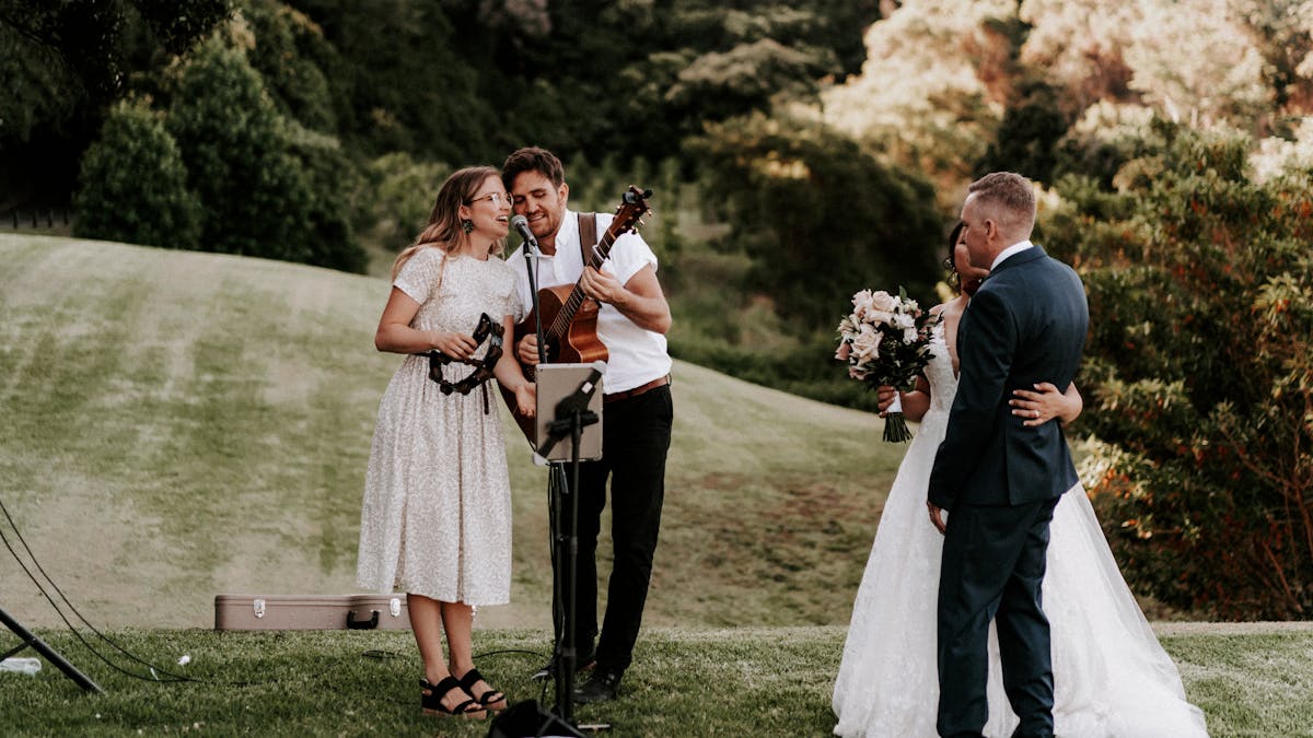 Acoustic Duo singing for a newlywed couple on hillside in Maleny