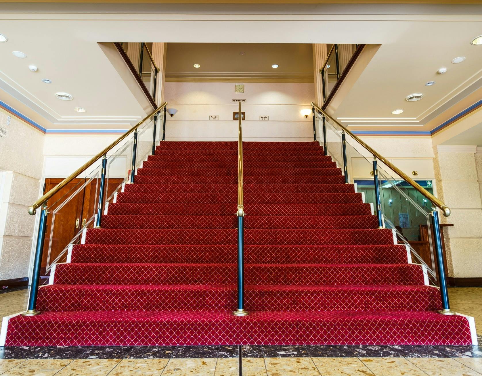 a red staircase inside Swan Hill Town Hall