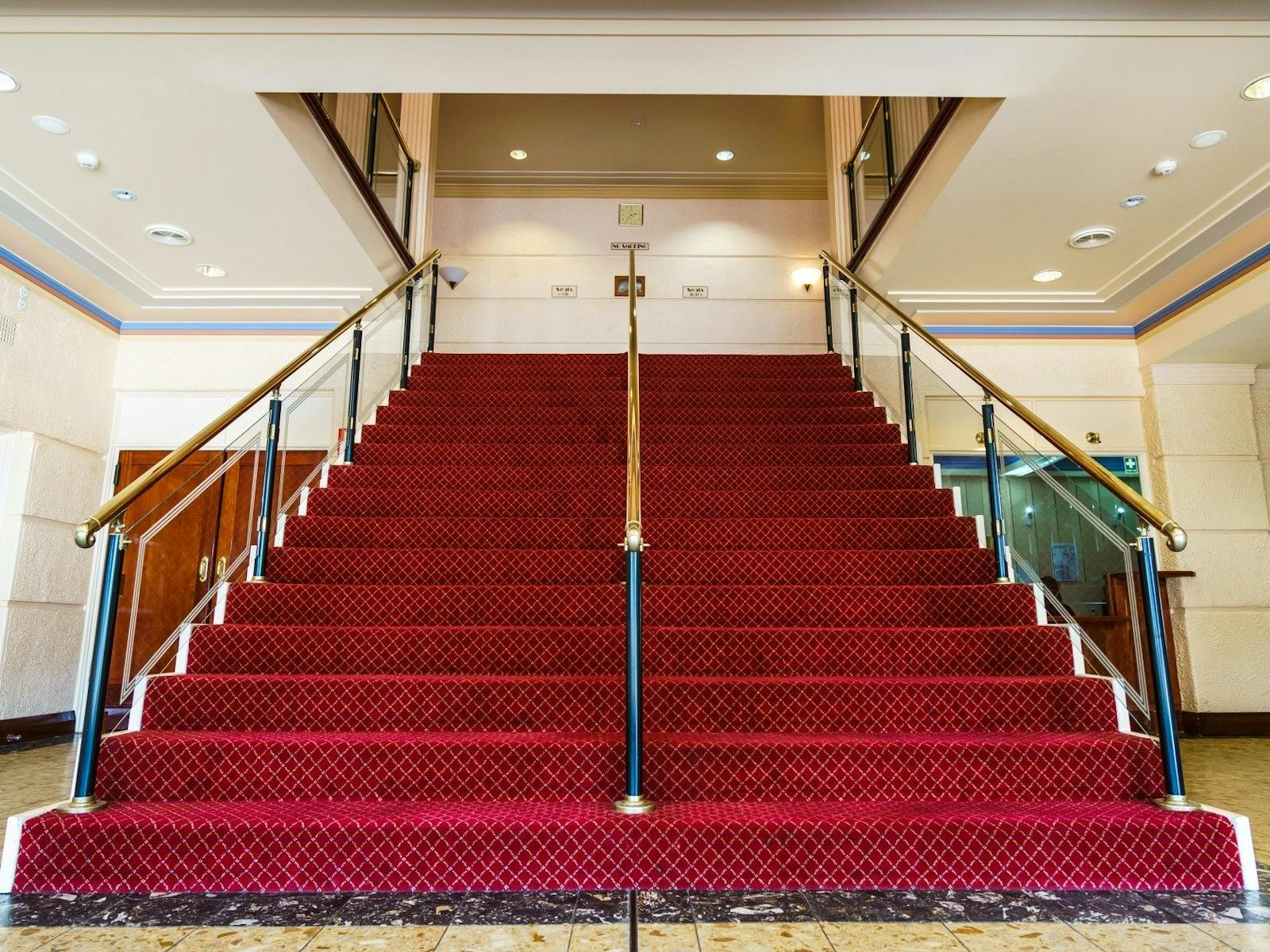 a red staircase inside Swan Hill Town Hall