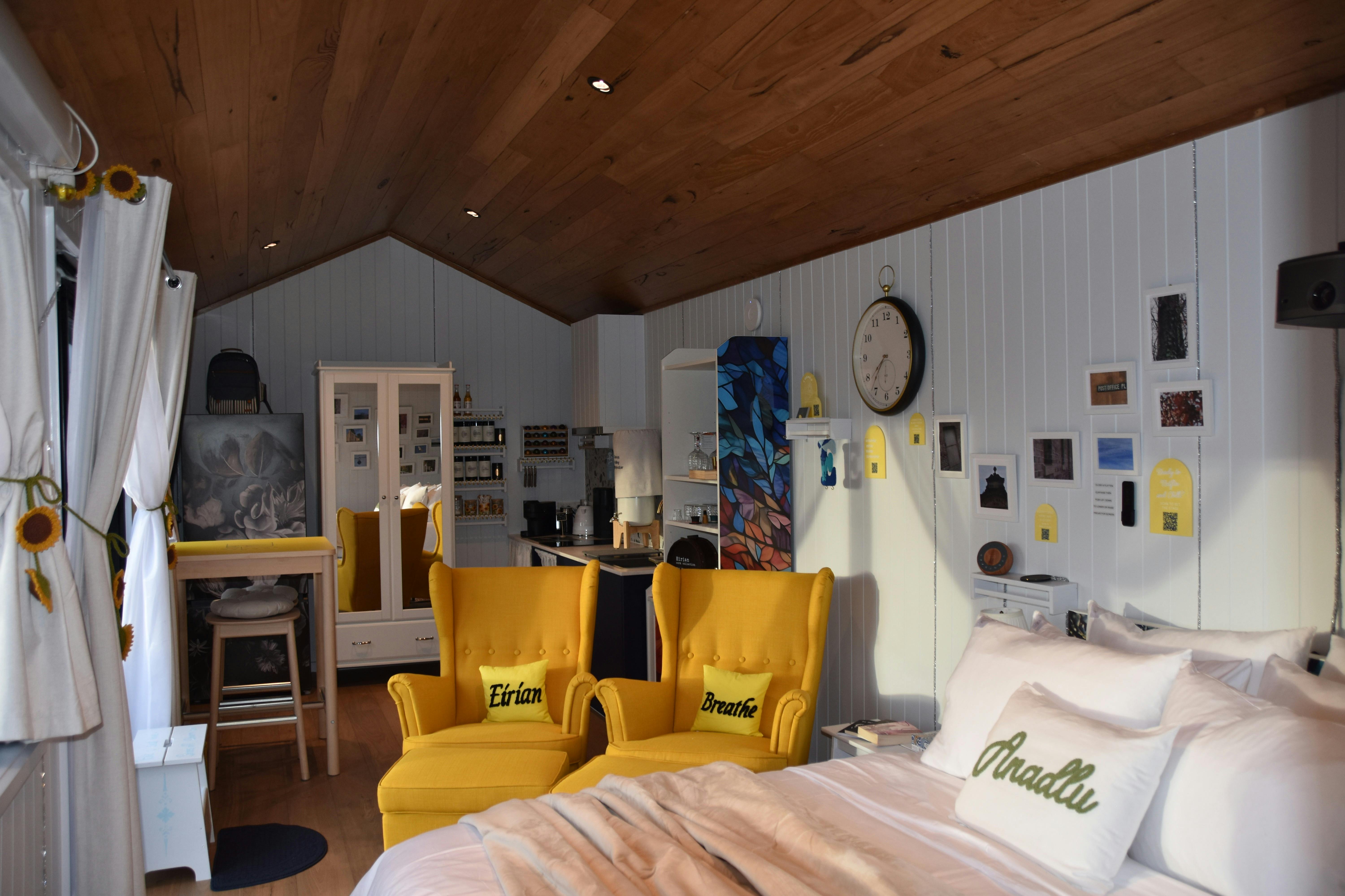 Interior view showing bed, seating, and windows with natural light.