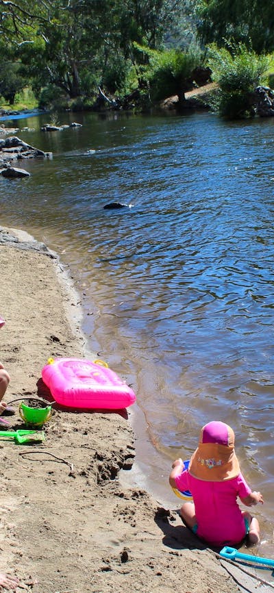 Children playing at one of the sandy river beaches at Elm Cottage