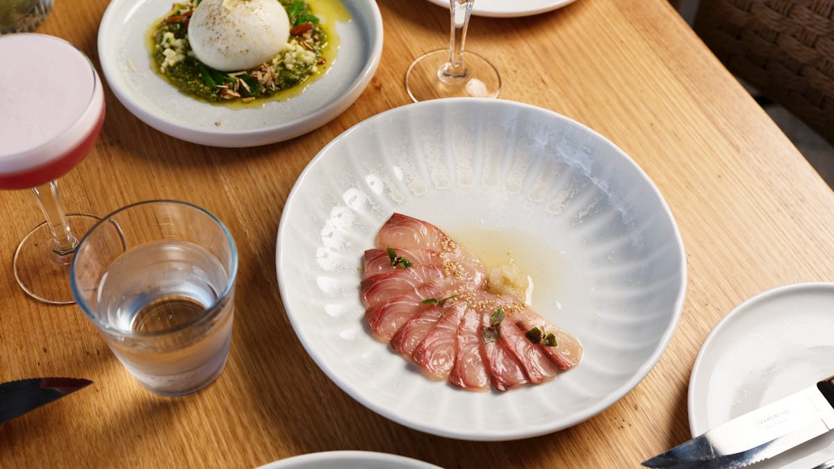 Hurricane's Surfers Paradise - Kingfish & Burrata plated beautifully on a wooden crafted table