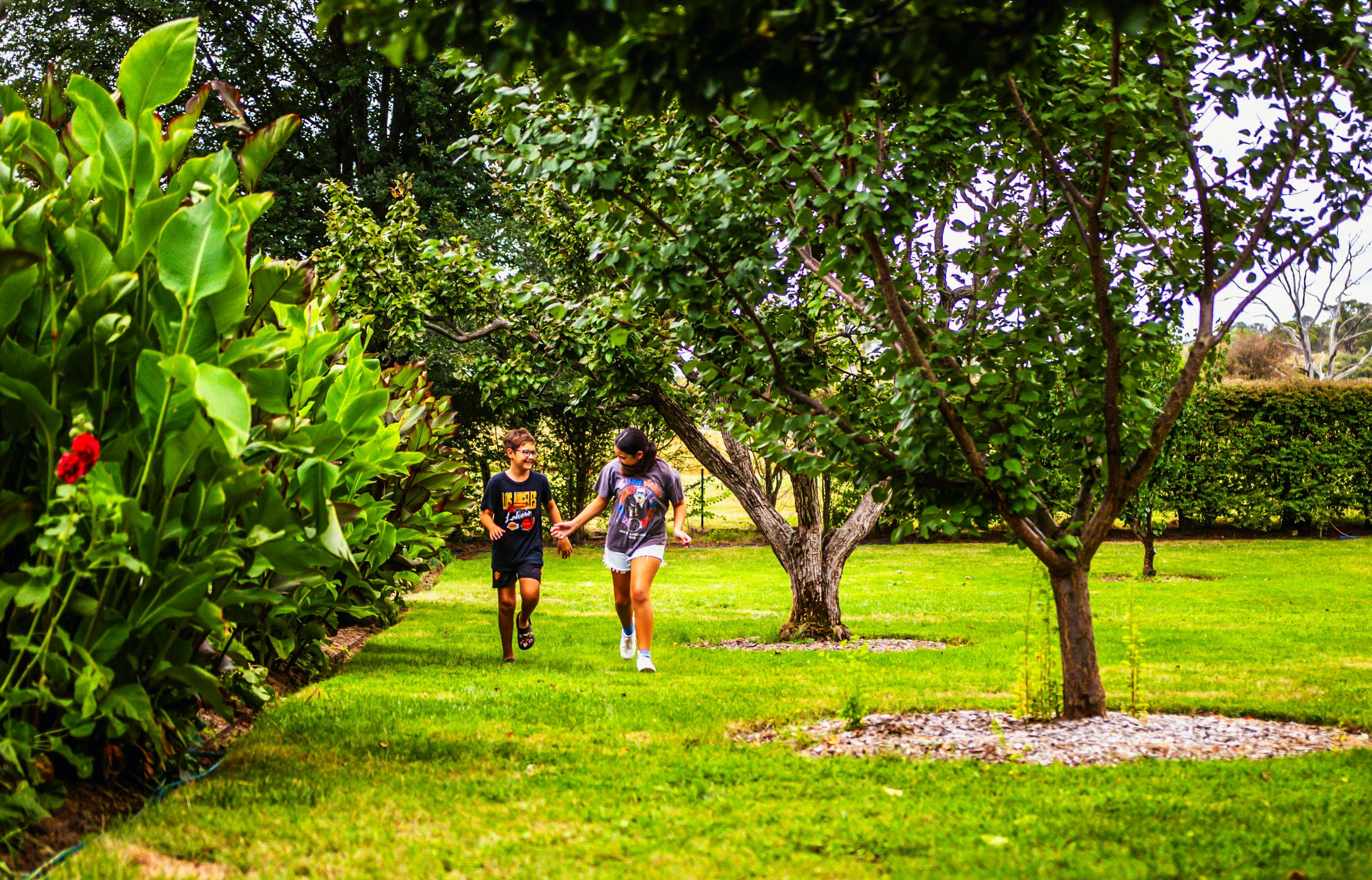Two young people exploring the grounds at Lanyon Homestead