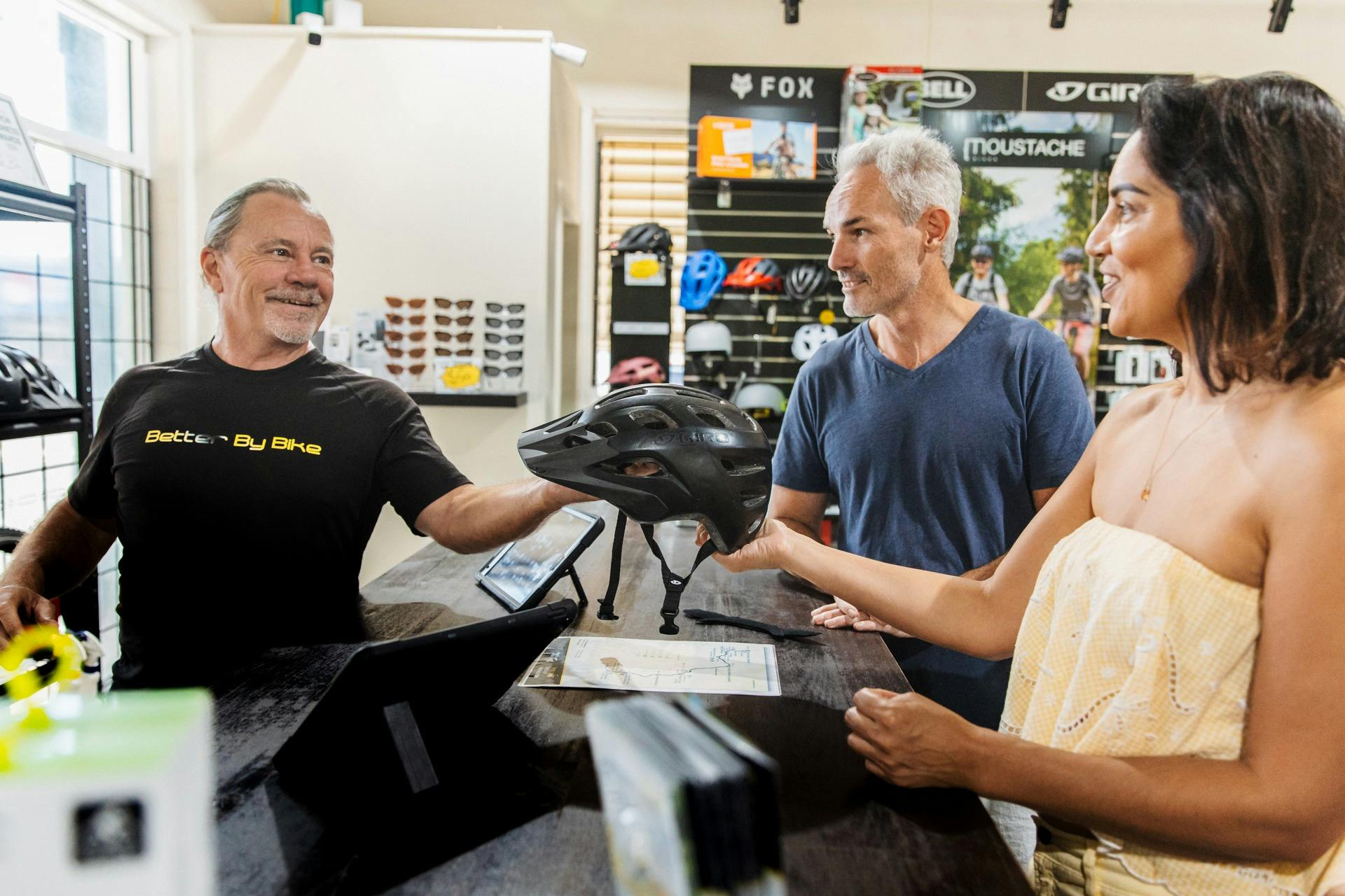 man giving customers bike helmet