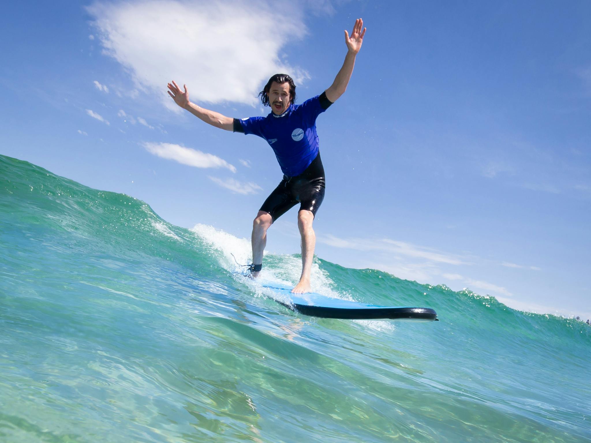 Guy surfing on wave