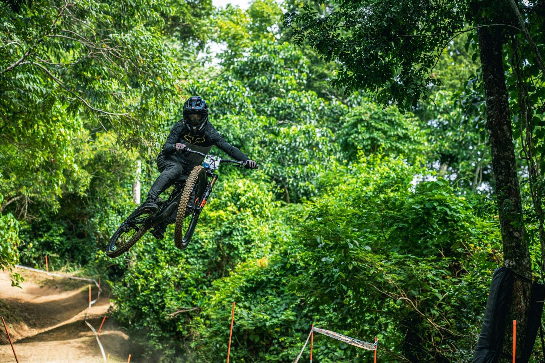 Downhill rider launches over a jump at Smithfield MTB Park.