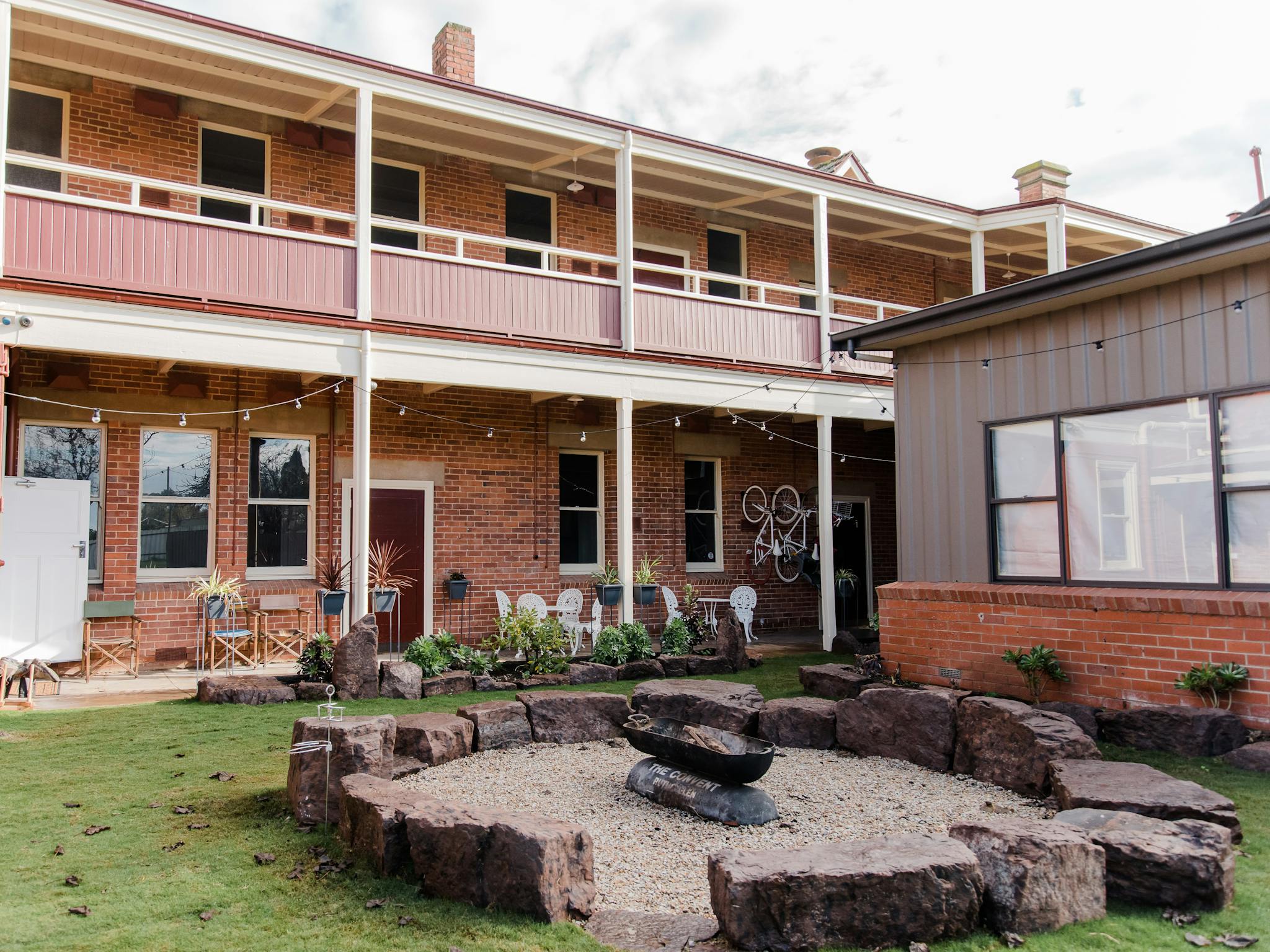 Outdoor entertaining area: firepit, festoon lights, grassed area