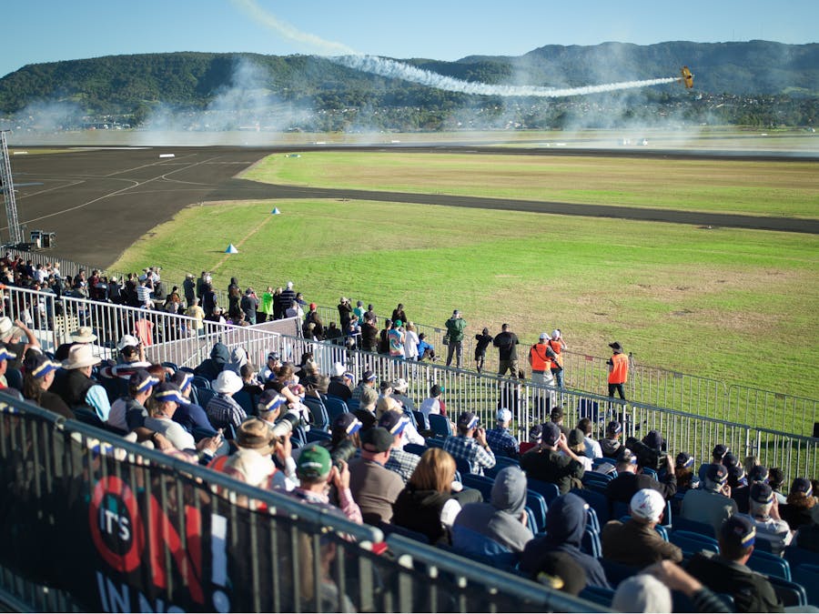 Grandstand crowd enjoying the close view of the display and mountains