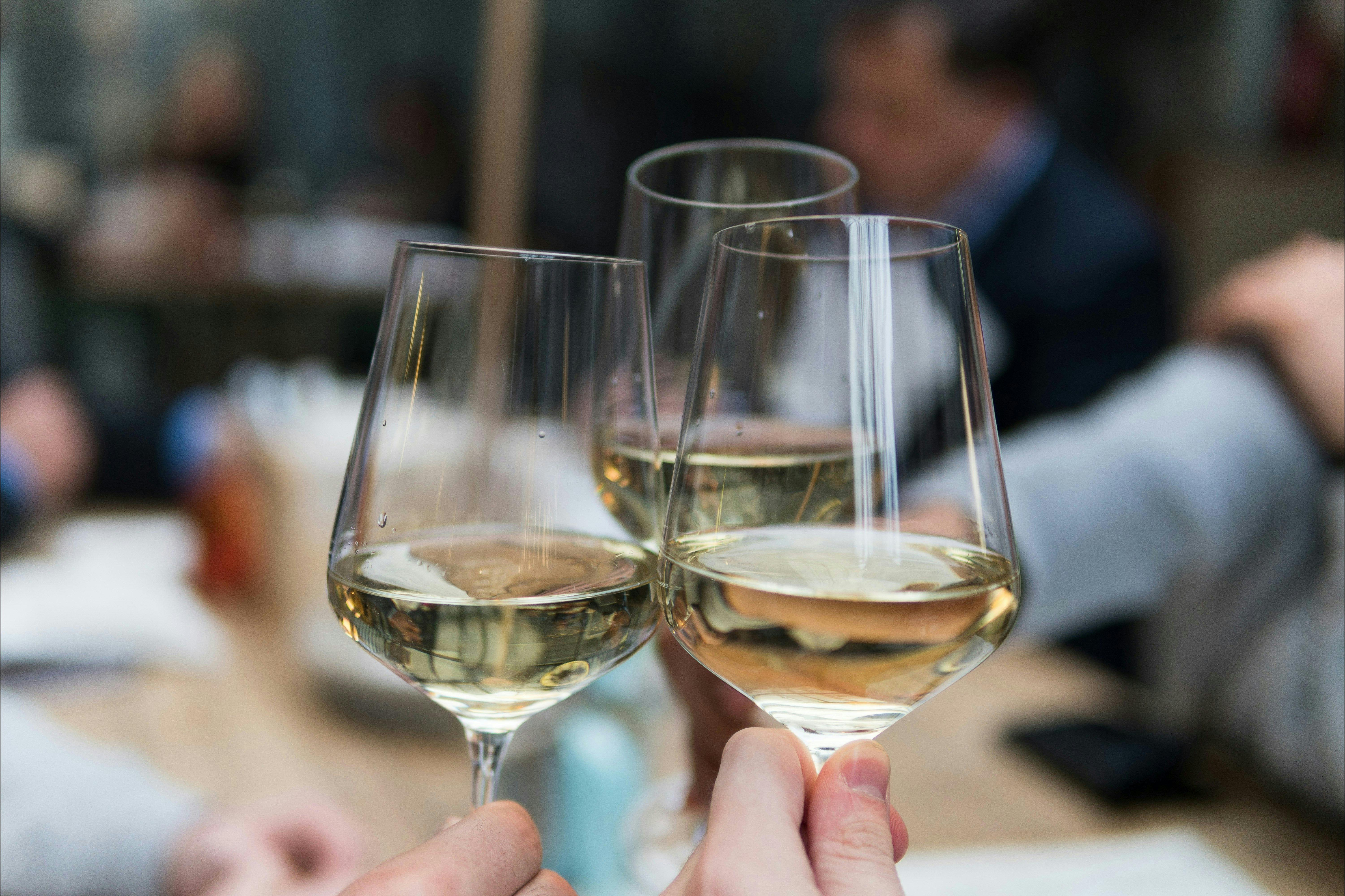 three white wine glasses cheers
