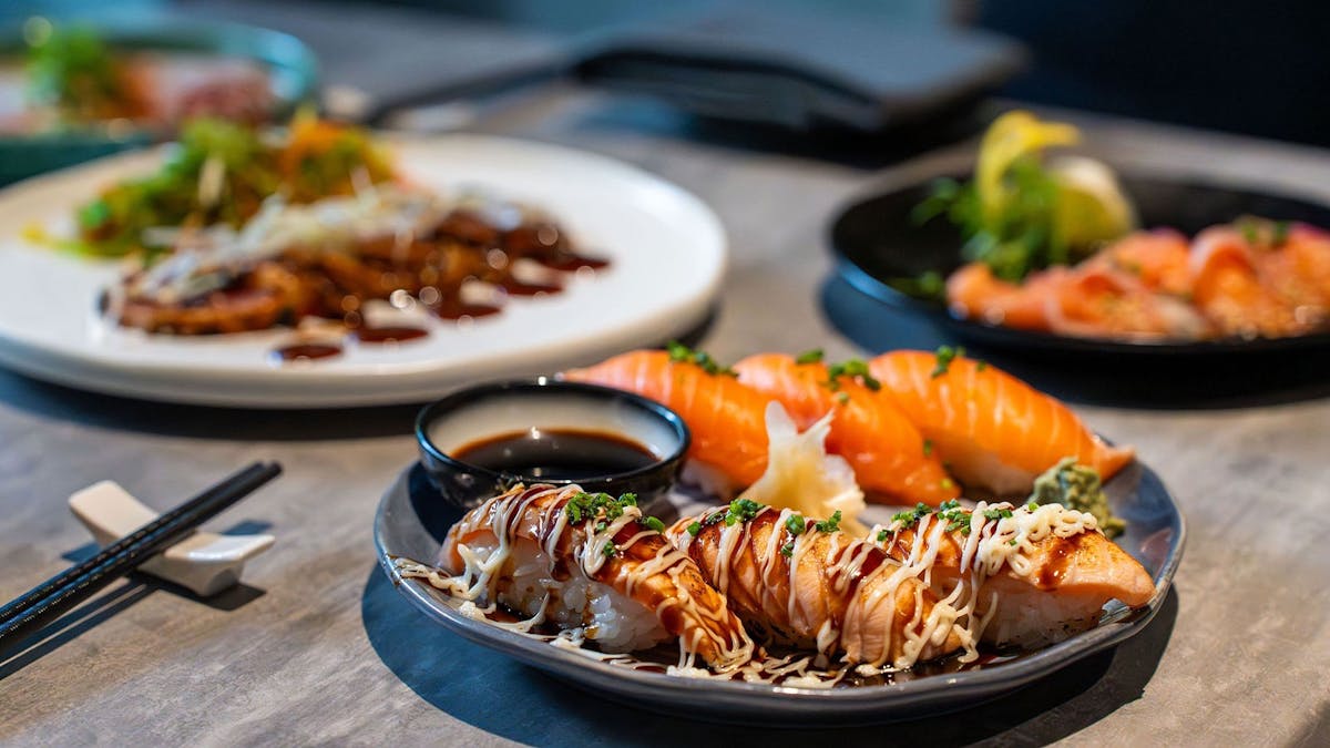 KOI Bar & Restaurant cold bites spread including nigiri & aburi, tuna tatami and salmon carpaccio.