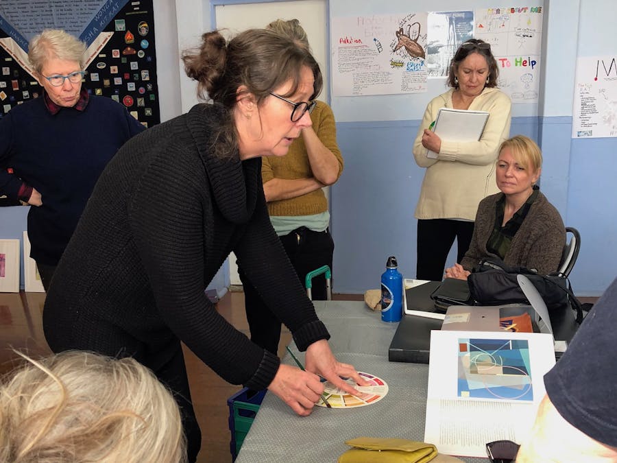 Megan critiquing students' works Kiama Art Workshops
